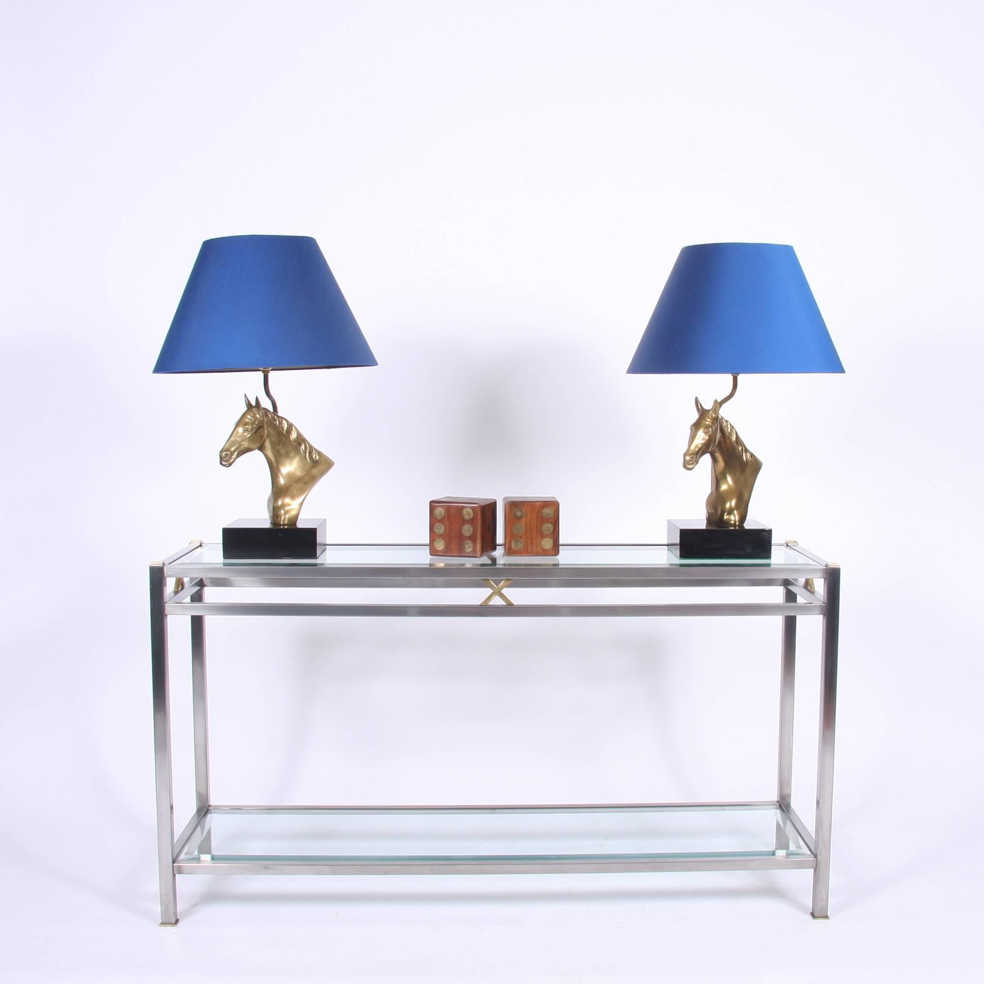 Brushed steel and brass console table, with two glass shelves, with bevelled edges. Modern and elegant, with great proportions.