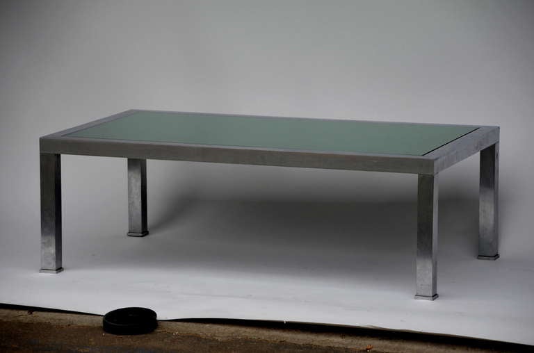Brushed steel and emerald mirror cocktail table by Guy Lefevre.