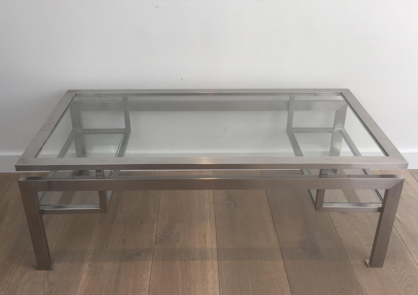 Guy Lefevre. Brushed steel coffee table or cocktail table with small glass on each side, circa 1960.