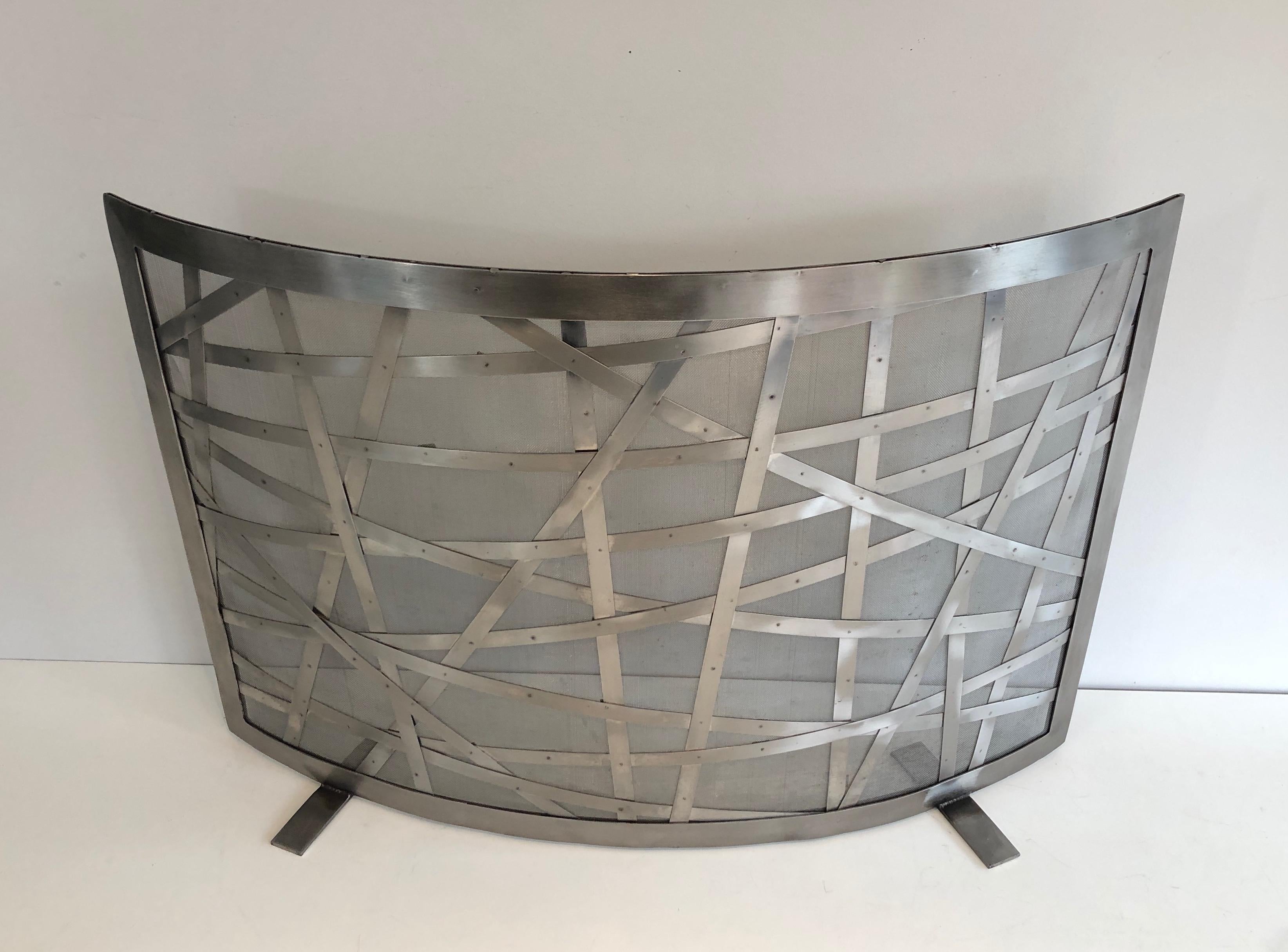 This design fire place screen is made of brushed steel. This is a unusual French design, circa 1970.