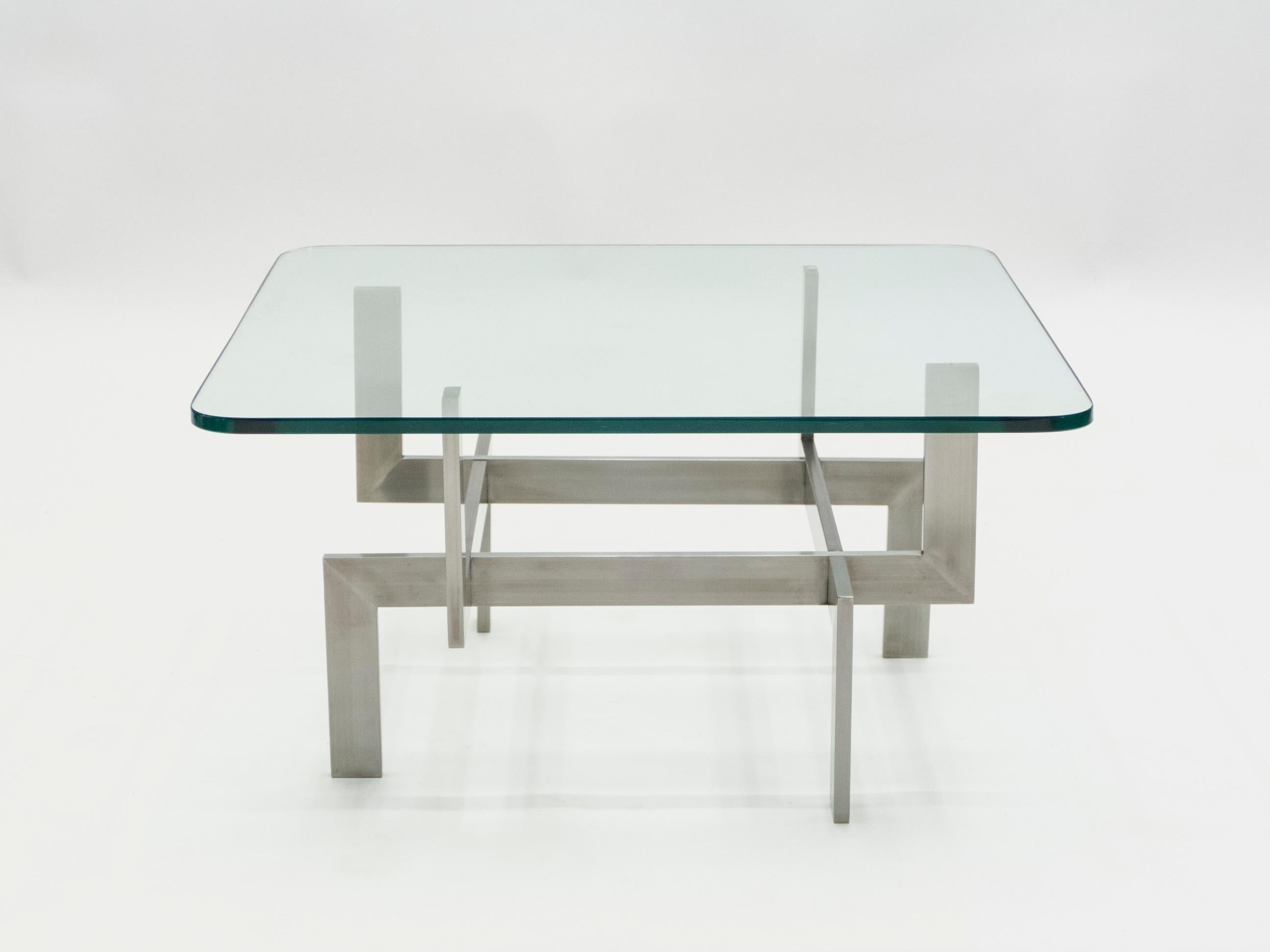Brushed steel features sharp, symmetrical angles in this coffee table by French designer Paul Legeard. Designed in the 1970s, the sleek midcentury designs got a sculptural upgrade with the legs fitting together like machinery beneath the thick,