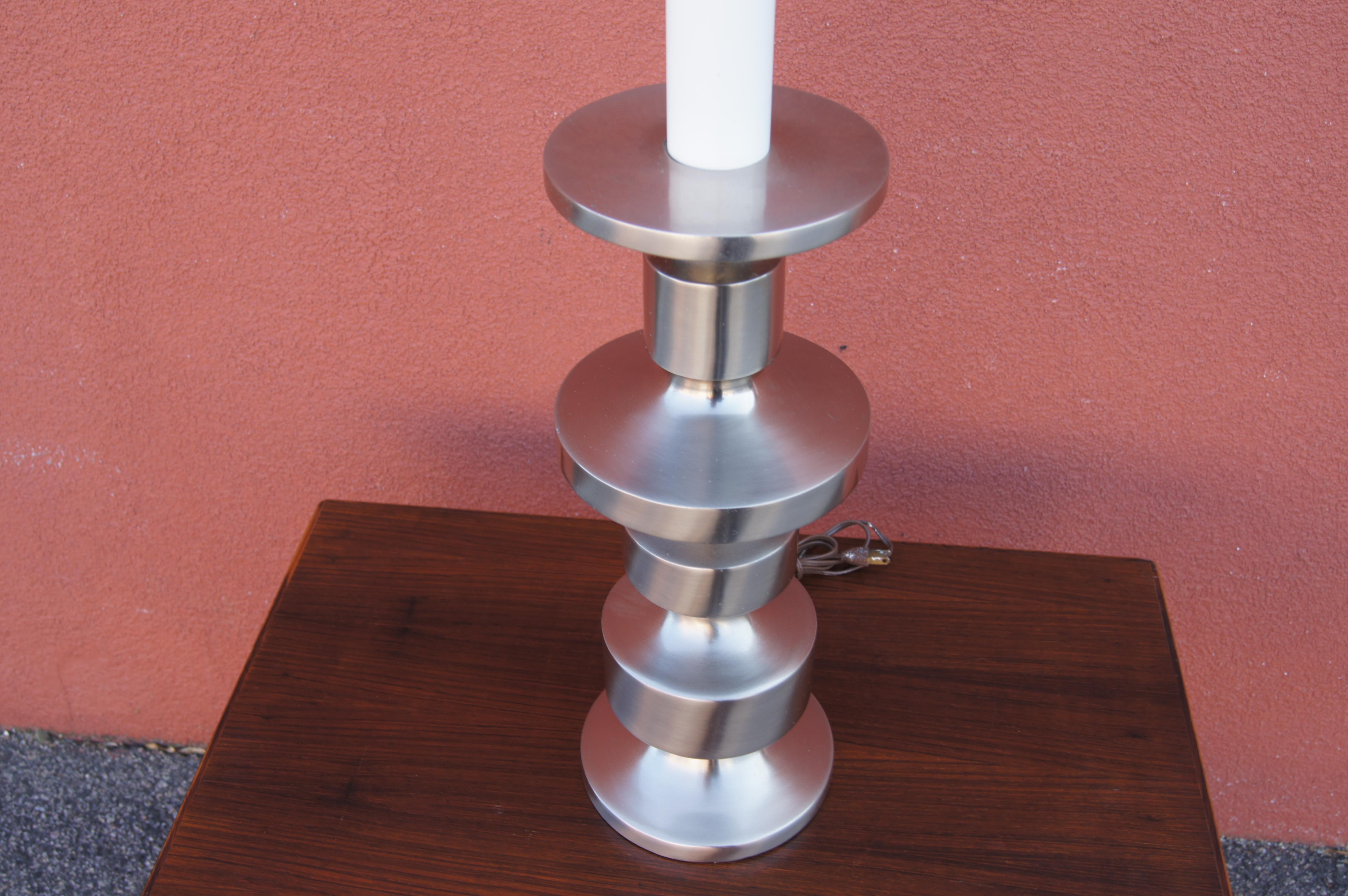 This handsome table lamp by Laurel features a body of brushed steel stacked as a totem.

The measurement below is to the top of the finial; the height to the top of the socket is 27.25 inches. 

Sold without a shade. We have two available.