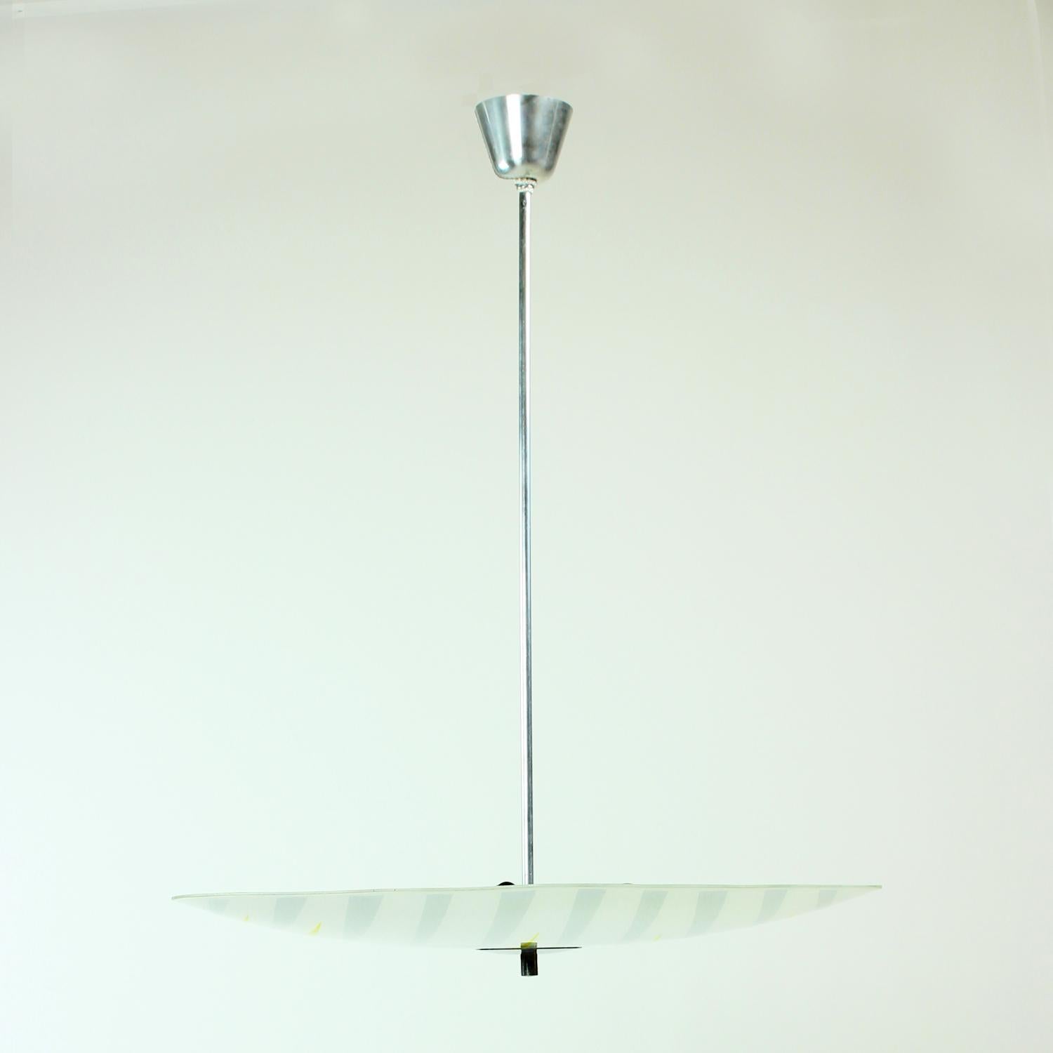 Very elegant glass plate light produced by Napako Company in Czechoslovakia in 1960s. The light is very typical for the midcentury design era, also known as Brussels era in Czechoslovakian design. This is the era of EXPO a design exhibition held in