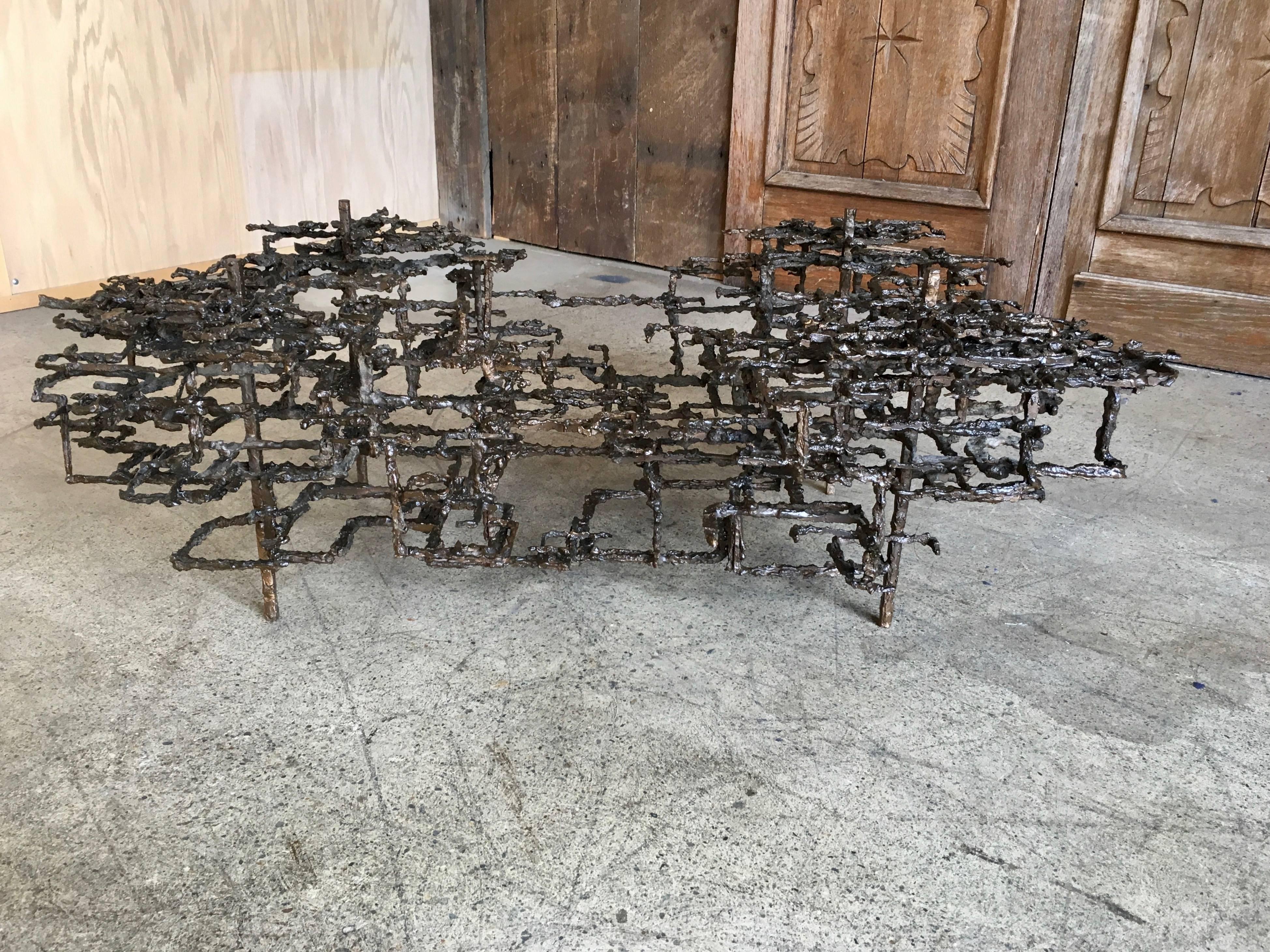 Table basse sculptée à la main en métal moulé avec une finition en bronze par Daniel Gluck.