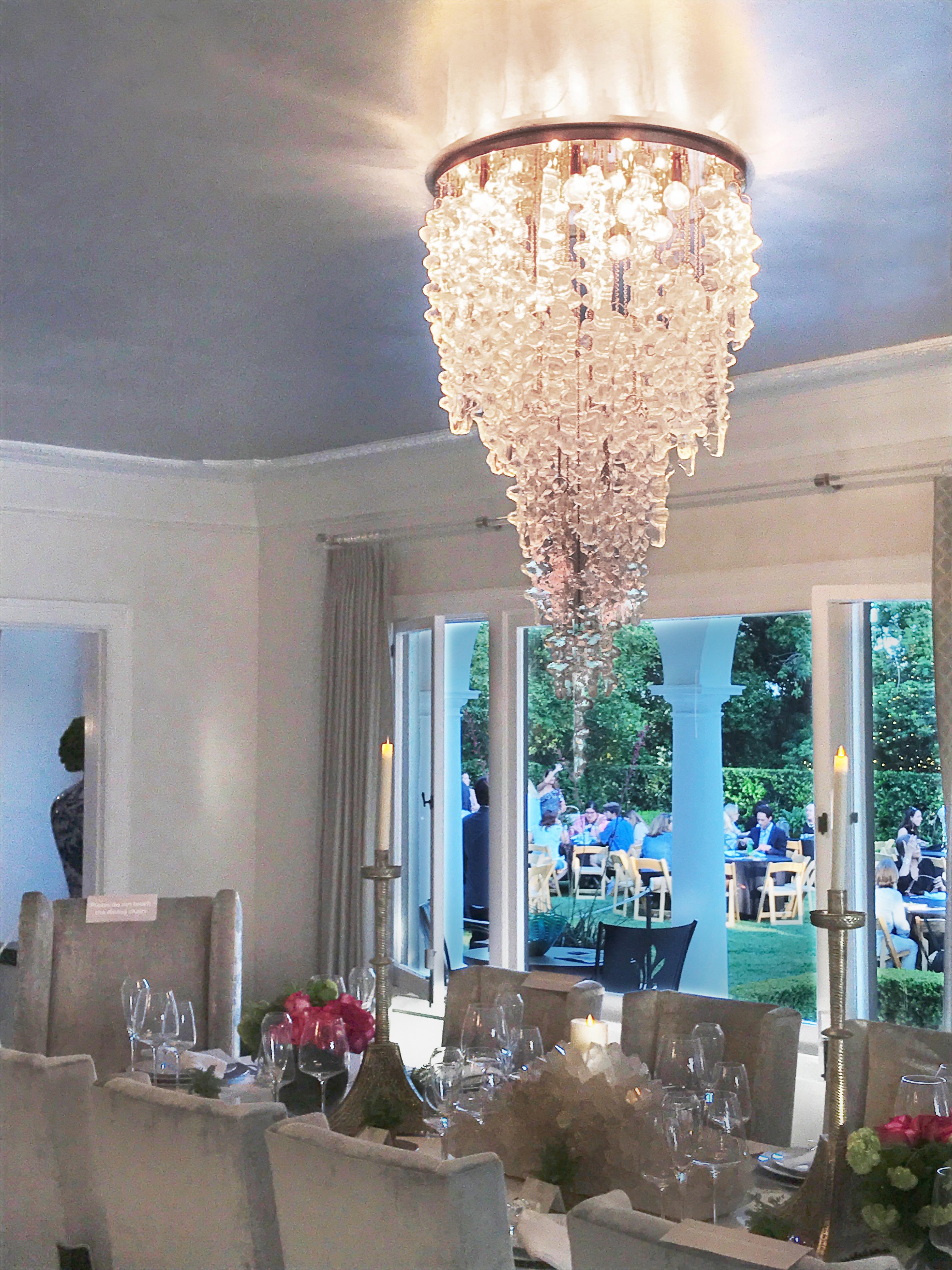 Tiers of organic Venetian glass forms, modeled after a brutalist sculpture, hang heavy yet light as air – like icicles melted in winter sun then frozen once more. Each BRUTALE glass piece on this chandelier, cast in quartz sand, glows with a fine