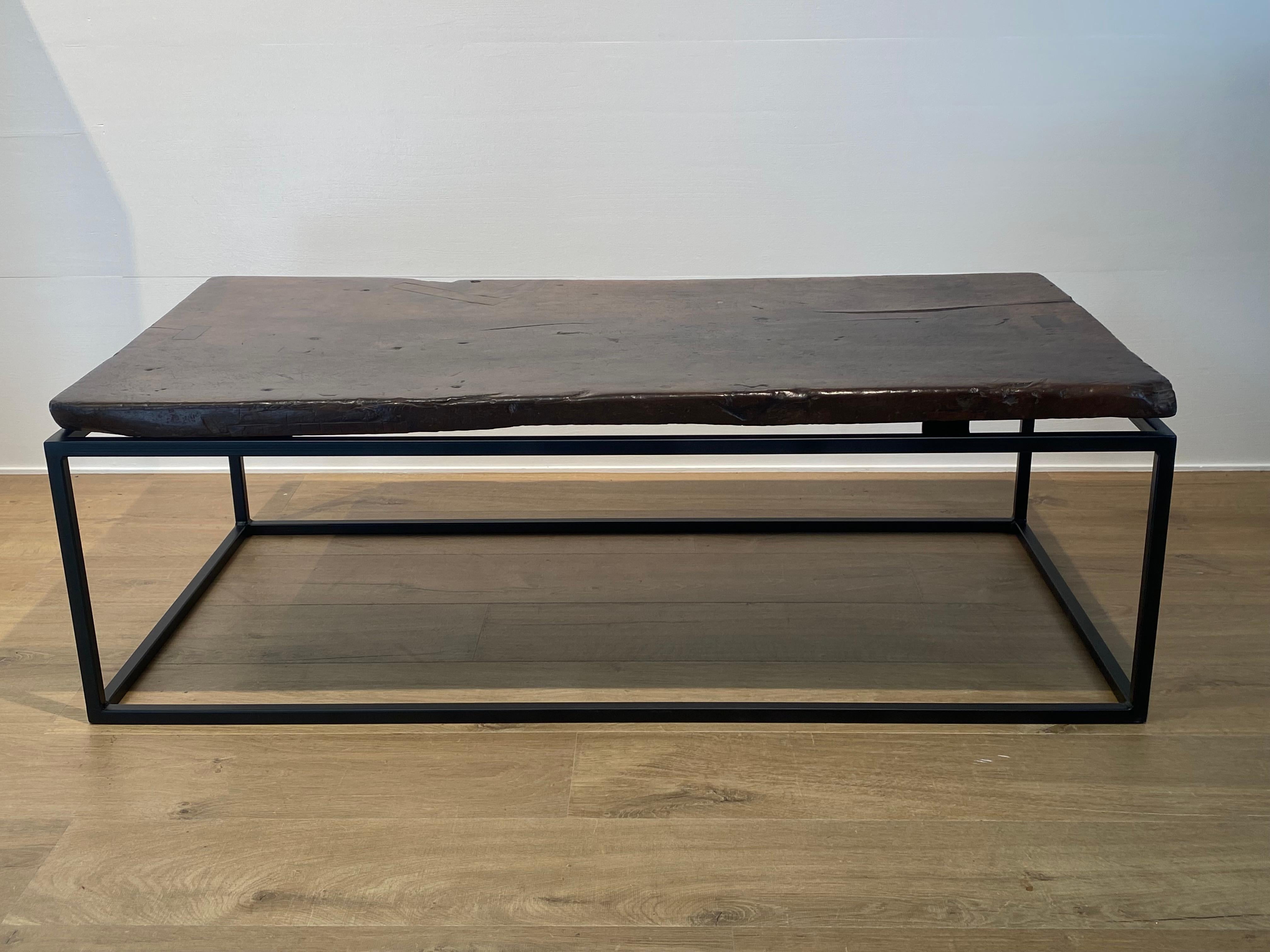Beautiful Coffee Table made out of an antique Spanish Walnut Table top
from the 18 Th Century, 
the table top has an exquisite patina and warm color and glance,
very powerful table on a contemporary base made of Iron,
table with a lot of character
