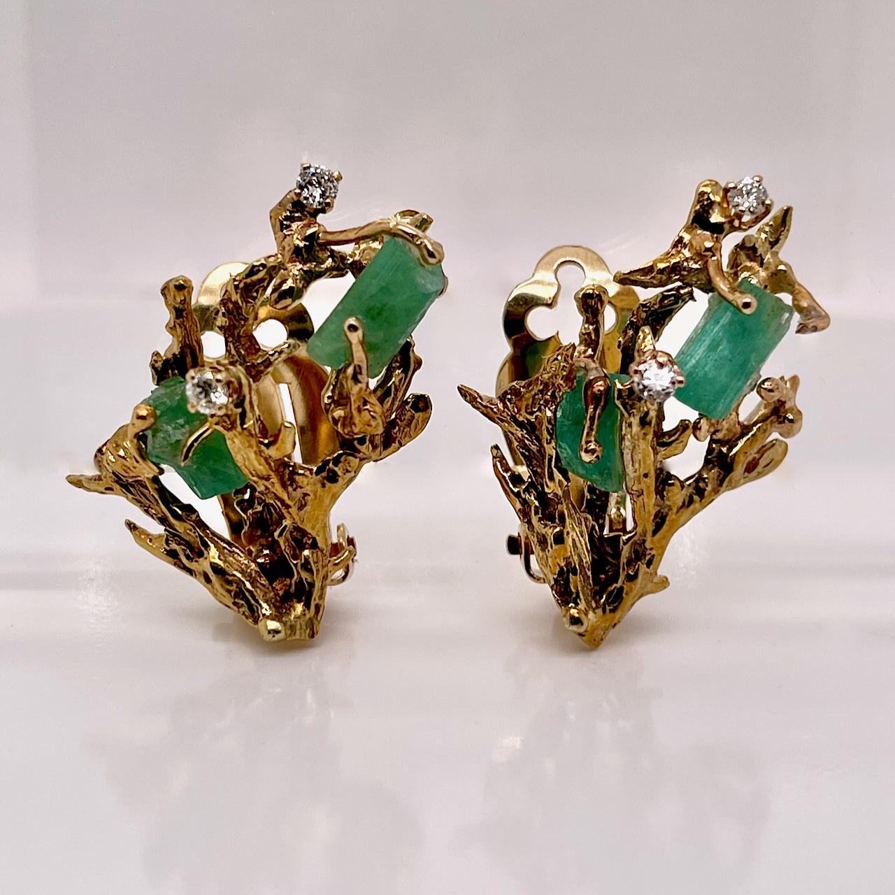 A very fine pair of 14k gold Brutalist earrings. 

Each set with two raw Chatham emeralds that are prong set in branch like settings and with two round brilliant diamonds prong-set in between the emeralds and branches. 

Simply terrific head-turning