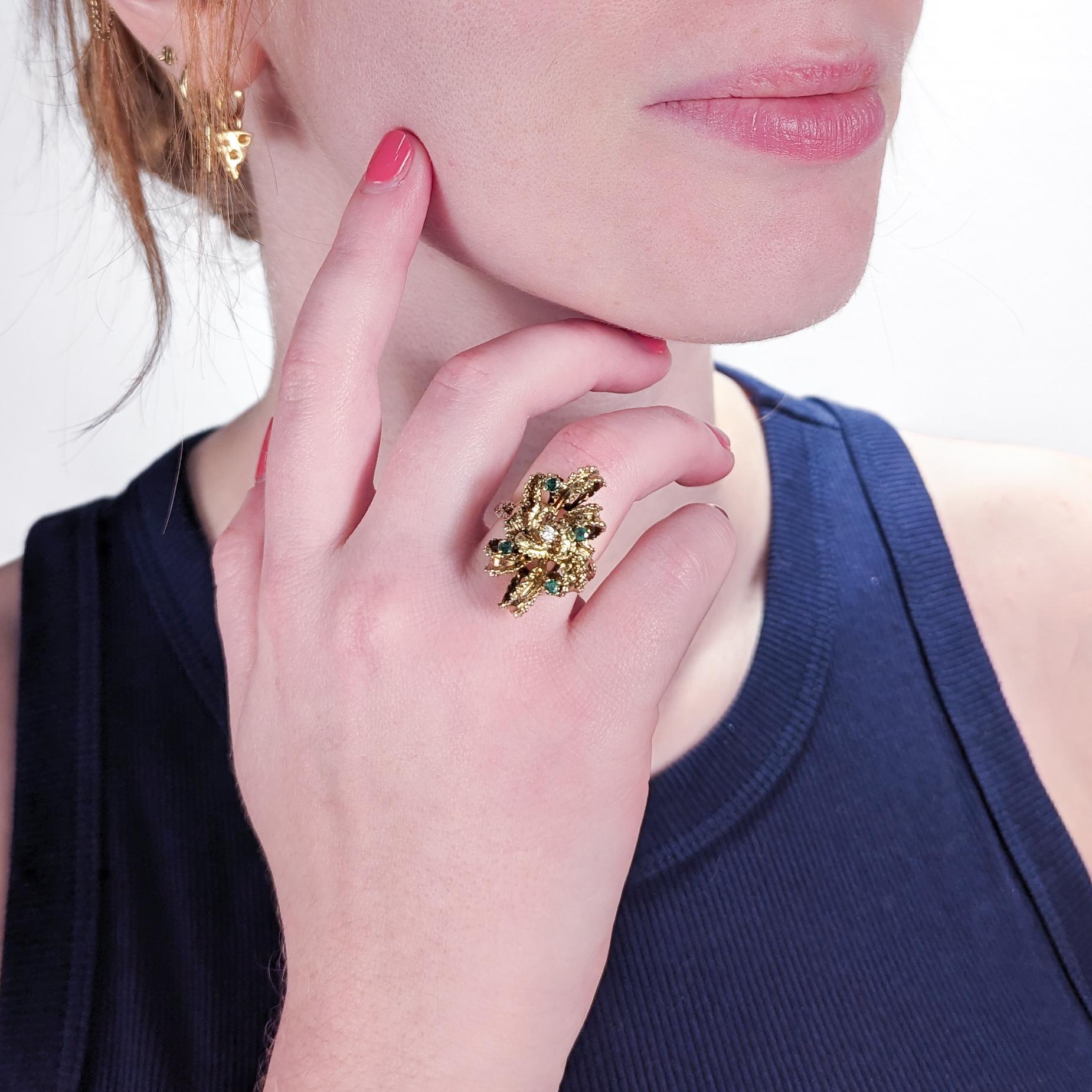 A fine bow-shaped brutalist 14K gold ring. 

A very wearable Mid-Century design comprised of textured ribbon set with small emeralds and a small diamond.

Ring Size: ca. 6 3/4
Width: ca. 5/8 in.

Items purchased from this dealer must delight you.