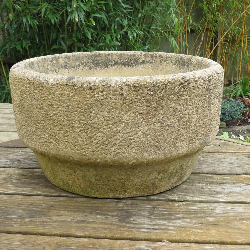 Solid concrete planter in the Brutalist style. Solid concrete with chiselled concrete decoration to the outside of the planter. It dates from the 1970s. Stamped to the inside of  pot 