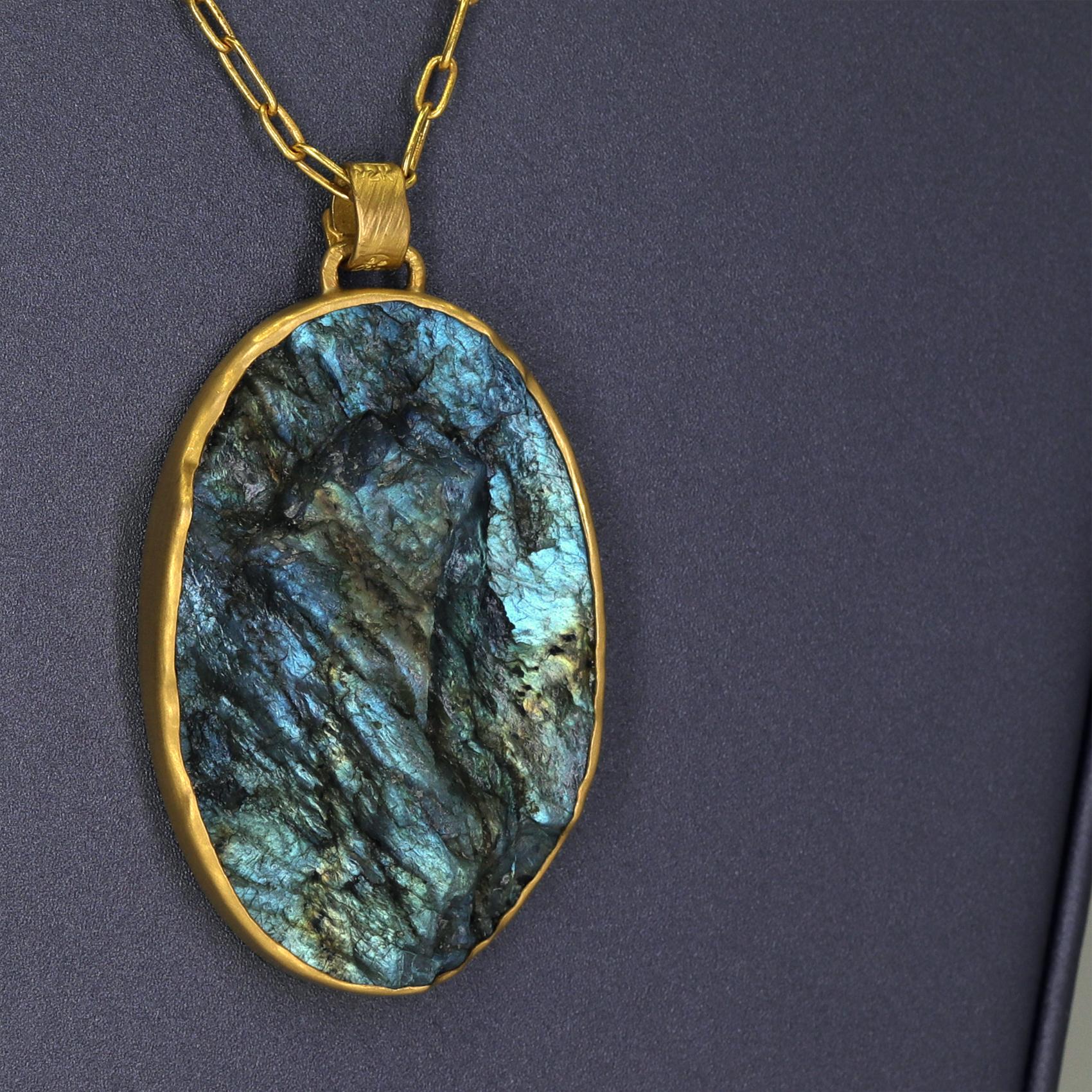 One of a Kind Brutalist Necklace by jewelry maker Lola Brooks showcasing a magnificent 94.6 carat chiseled labradorite oval with stunning labradorescence, hand-fabricated in the artist's signature-finished 22k yellow gold bezel and finished on a