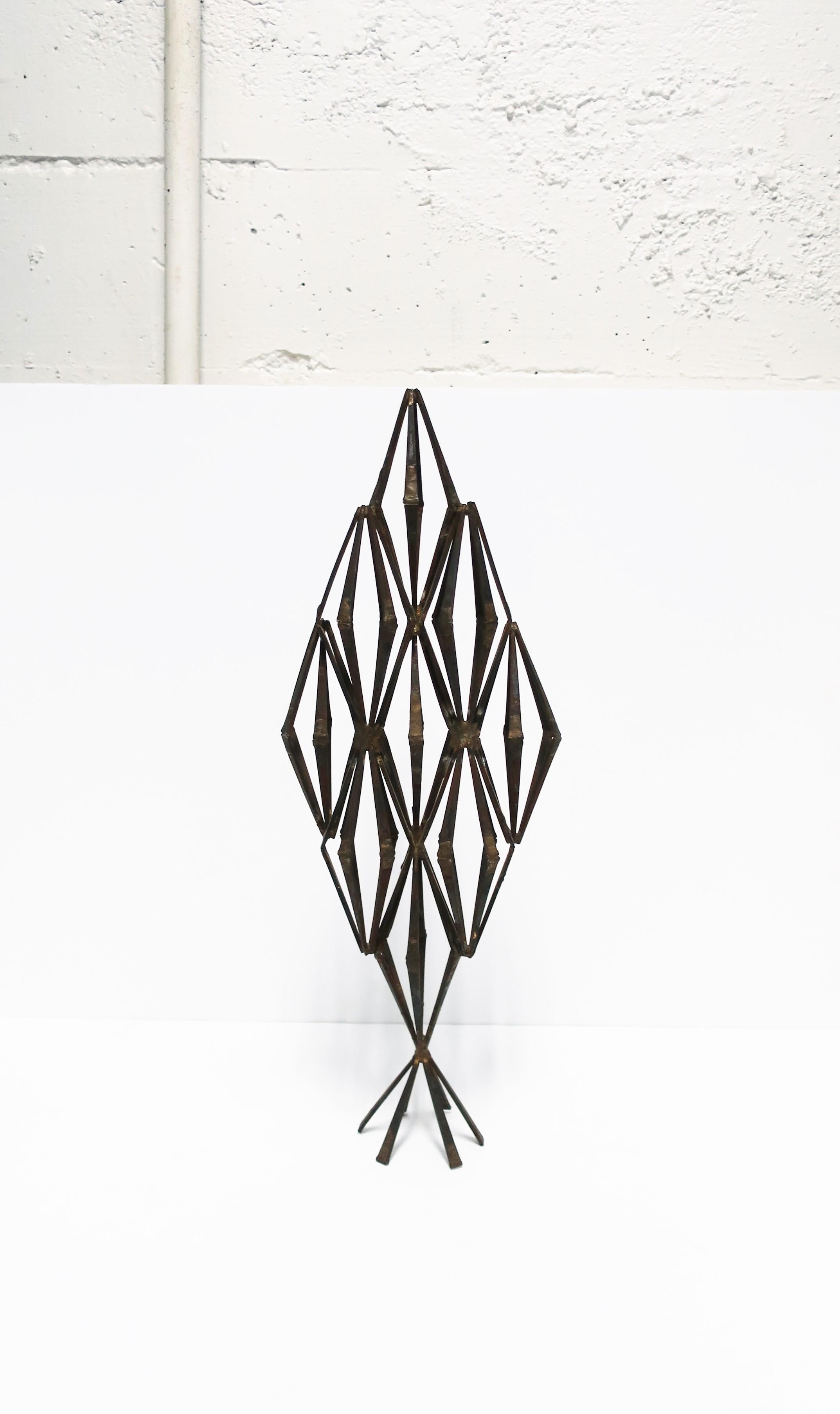 A hand-made brutalist metal sculpture piece in a marque shape, circa late-20th century. Sculpture is relatively tall made of iron metal with an intentional weathered look giving it a bronzed hue. Dimensions: 3.75