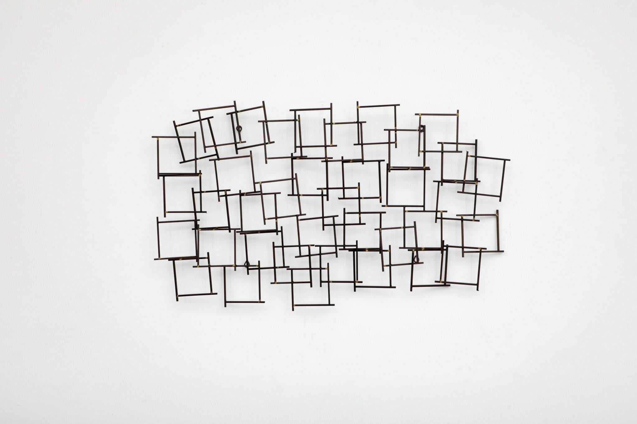 Large Abstract welded iron Brutalist sculpture with a nod towards artists such as Harry Bertoia and William Bowie. Curtis Jeré inspired, this refined wall art has a wild crisscross of violent intersections made from cut large iron nails or spikes.