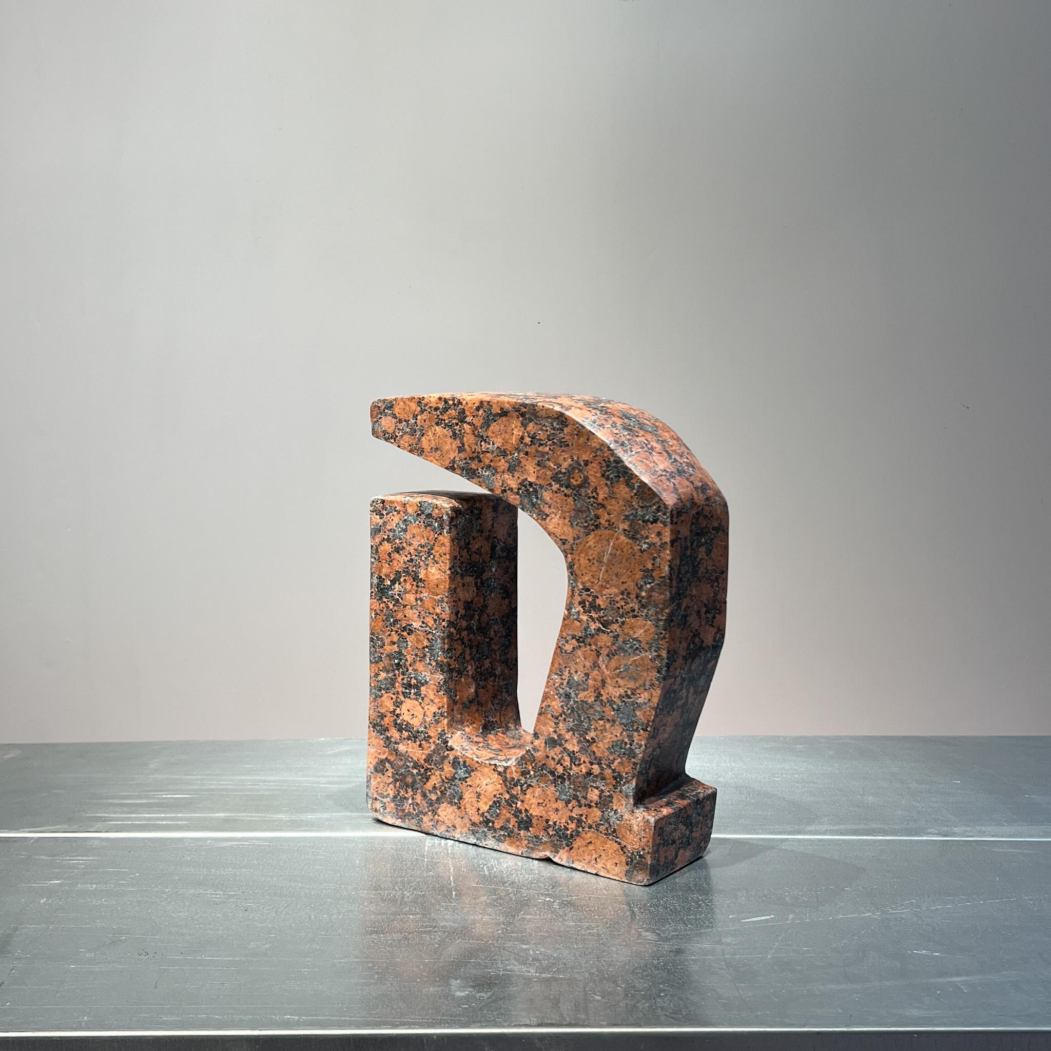 Handcarved  sculpture of a abstract shape in brutalist style,
This sculpture with in a stunning pink granite texture emphasizes the strong abstract shape. 

This sculpture with its rounded shapes, creating a composition that emphasizes the