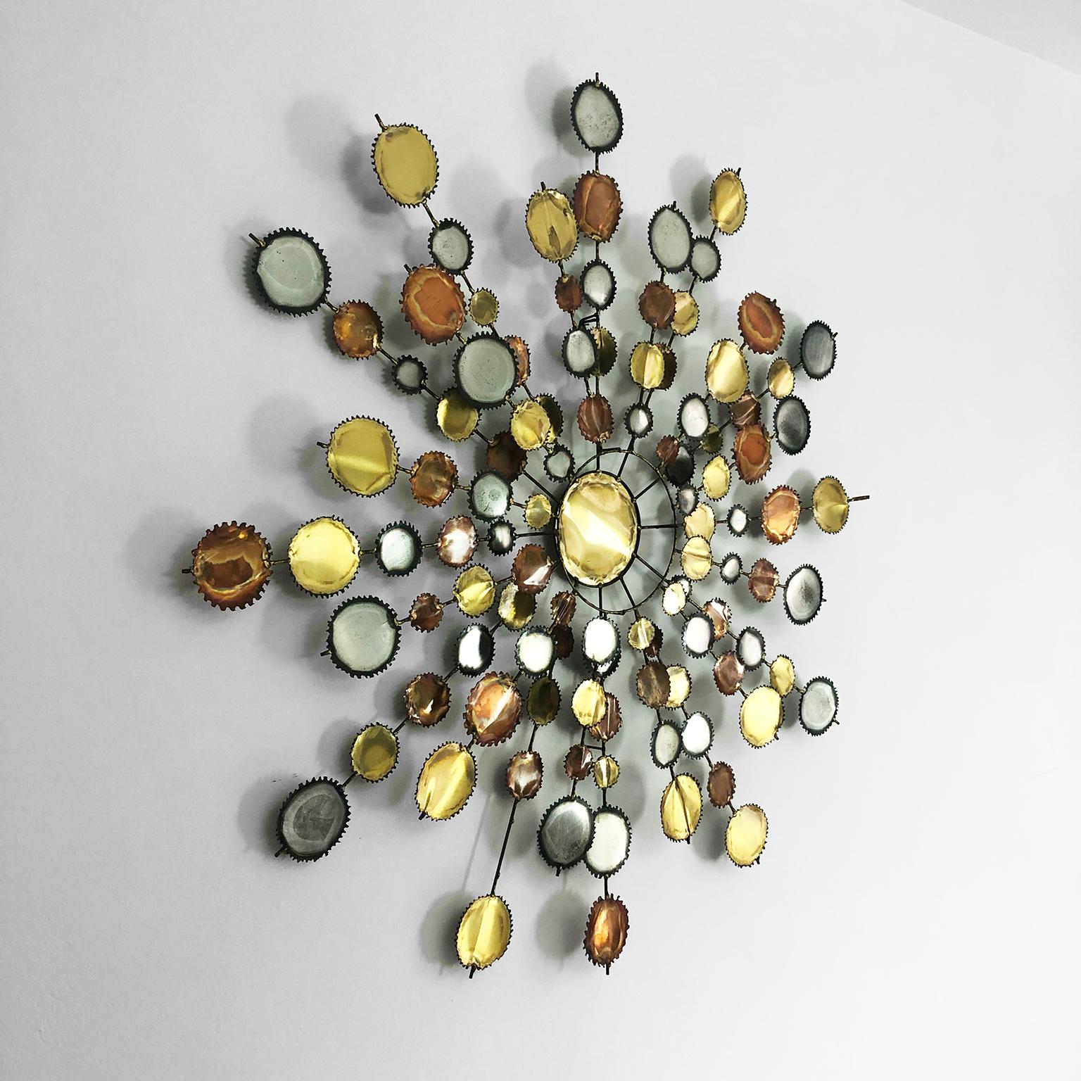 We offer this large diameter wall sculpture in the style of C. Jere, circa 1960.