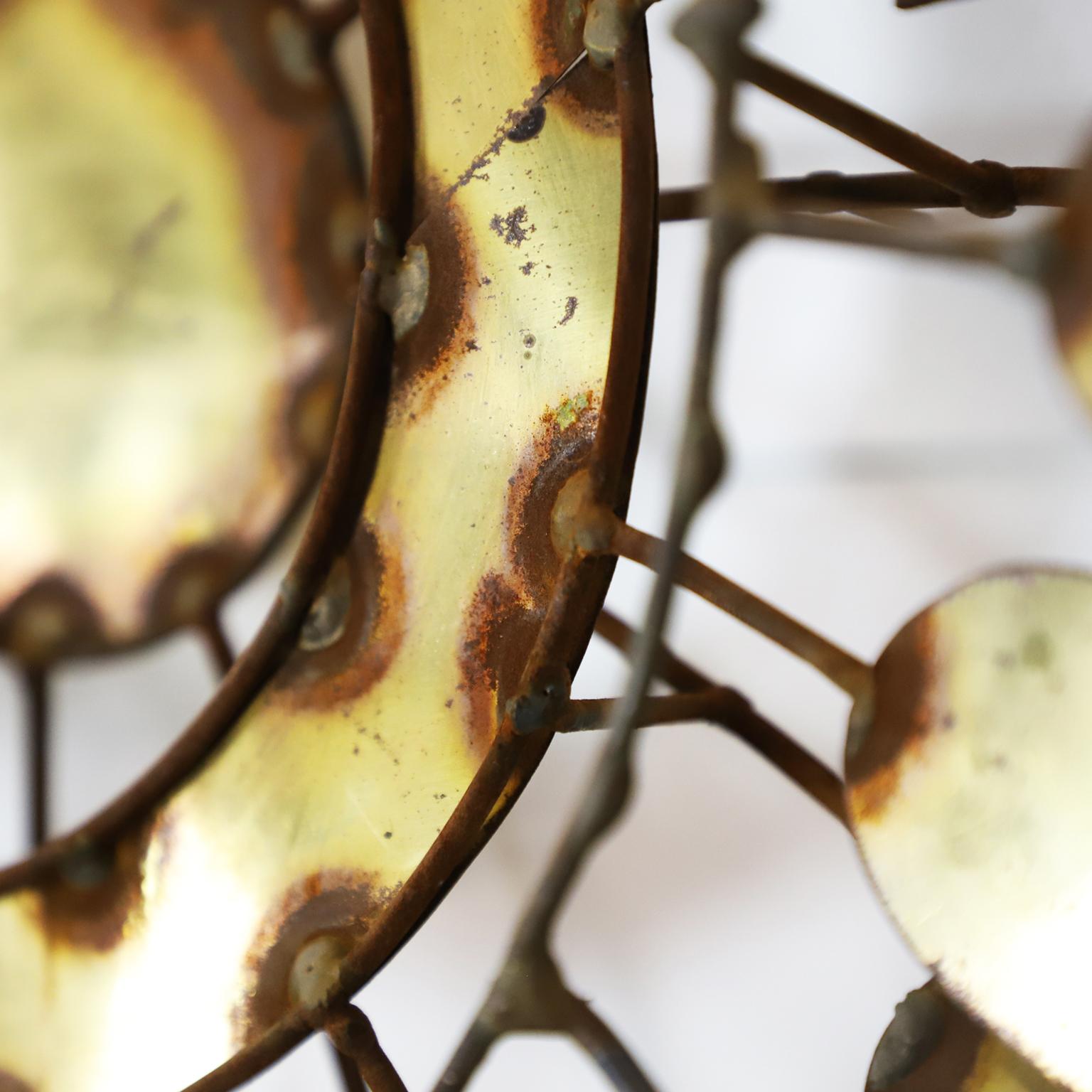 We offer this large diameter wall sculpture in the style of C. Jere, circa 1960.