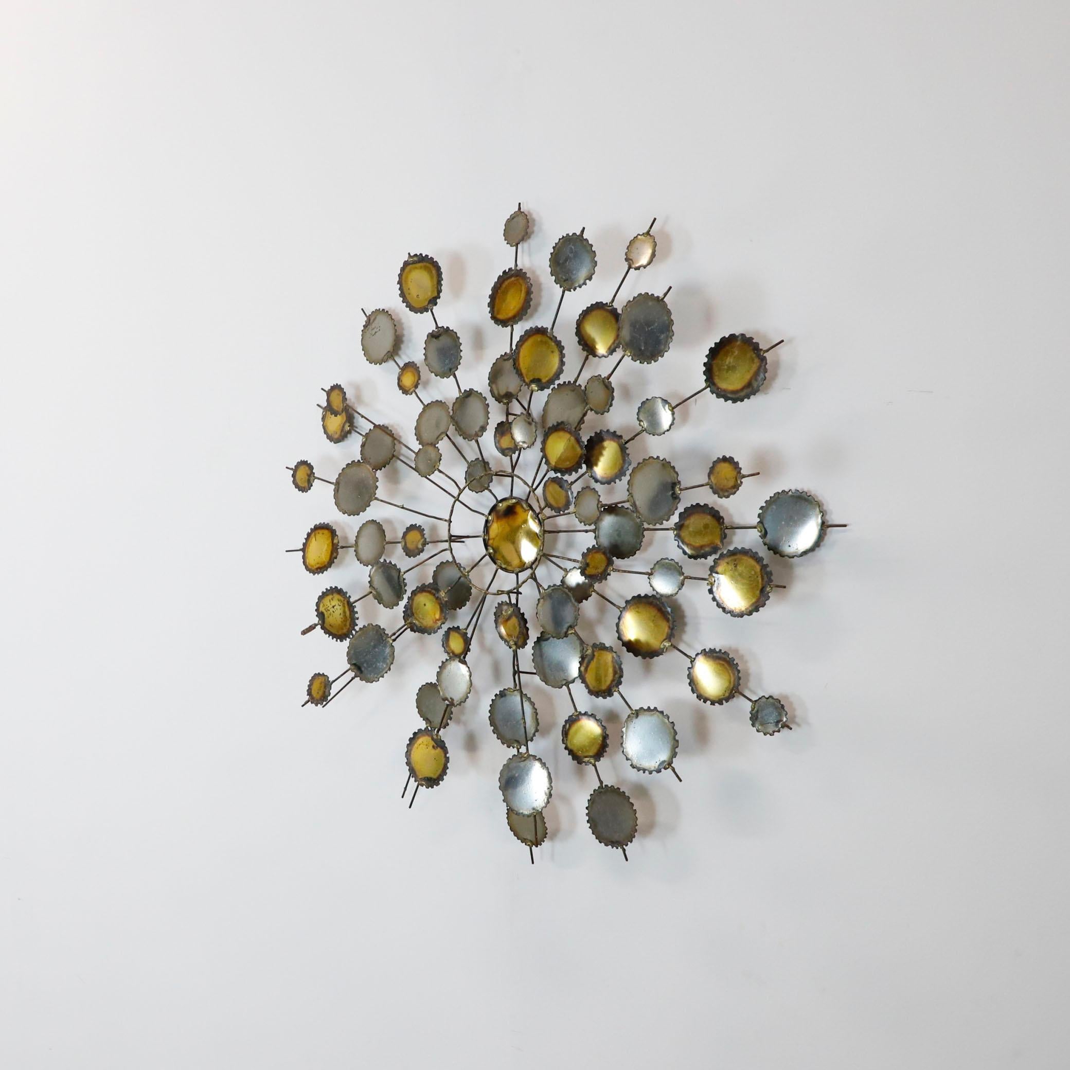 We offer this large diameter wall sculpture in the style of C. Jere, circa 1960.