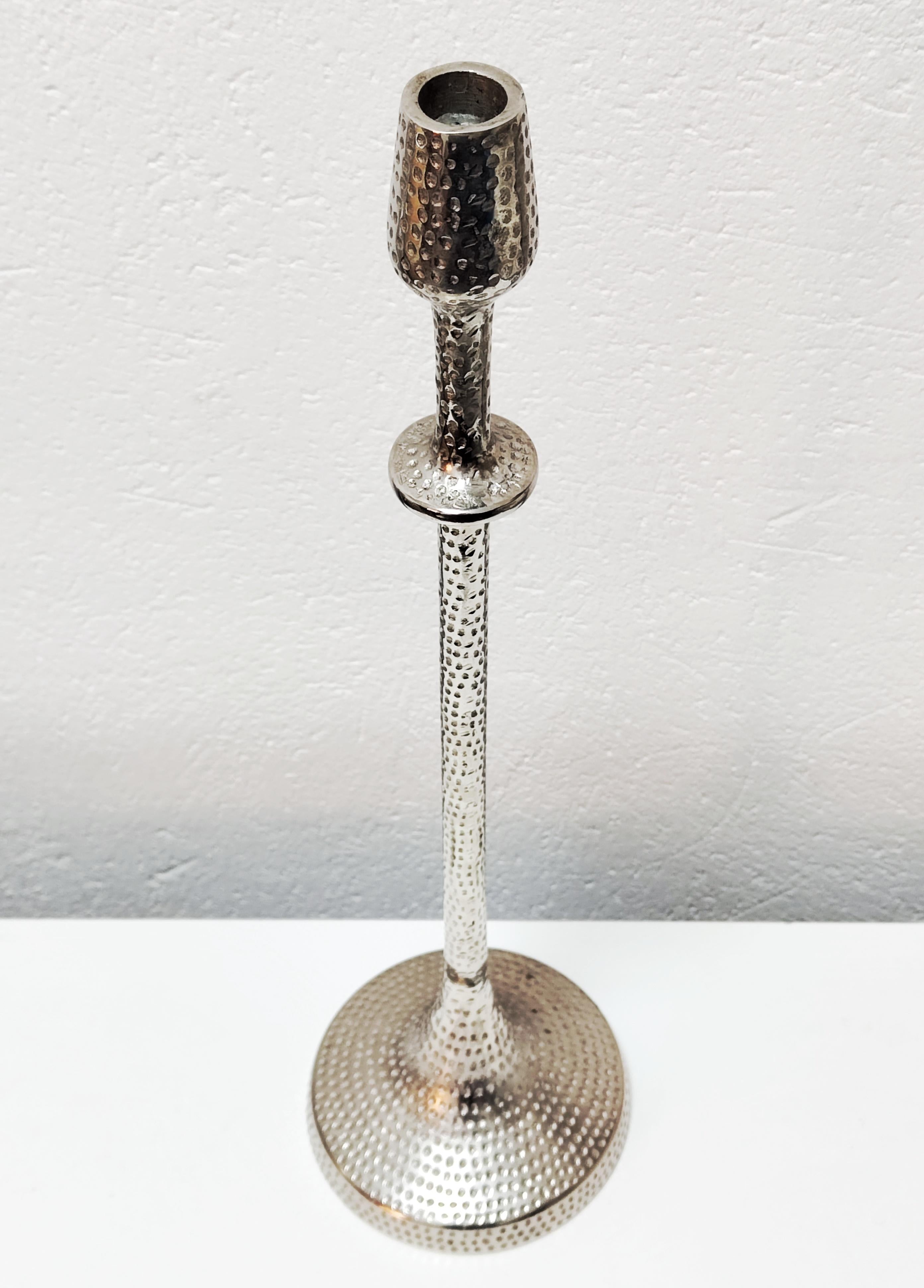 In this listing you will find a large Brutalist candlestick holder designed by Gunther Lambert. The candlestick holder is done in hammered aluminum, featuring beautiful and sleek design. Made in West Germany in 1970s.

Very good vintage condition