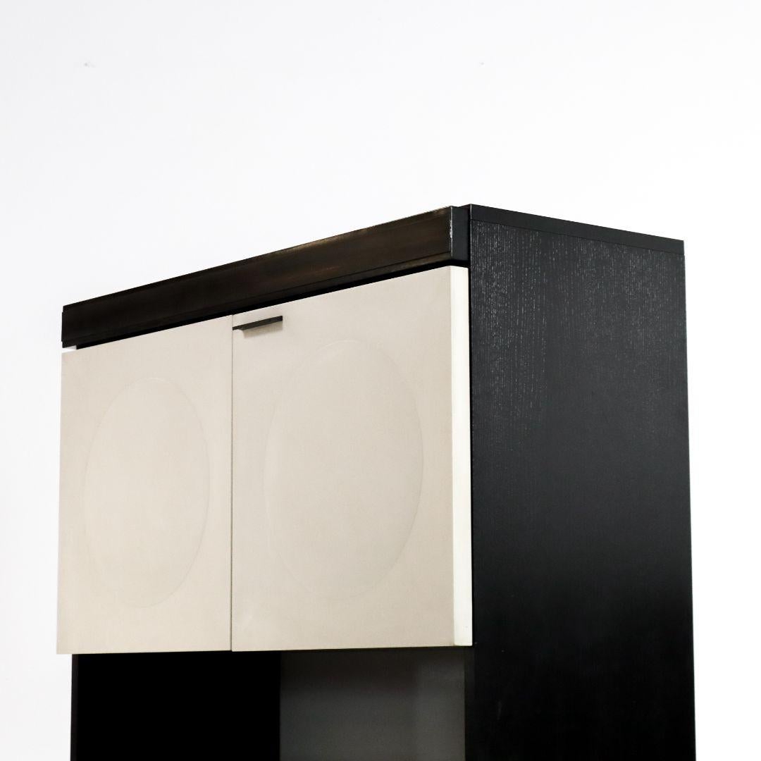 1970s Brutalist bar cabinet from Belgium, beautifully designed with ample space and a convenient gap between the two sections. The white doors create a nice contrast with the soft grain of the black oak wood. The cabinet is in good vintage condition