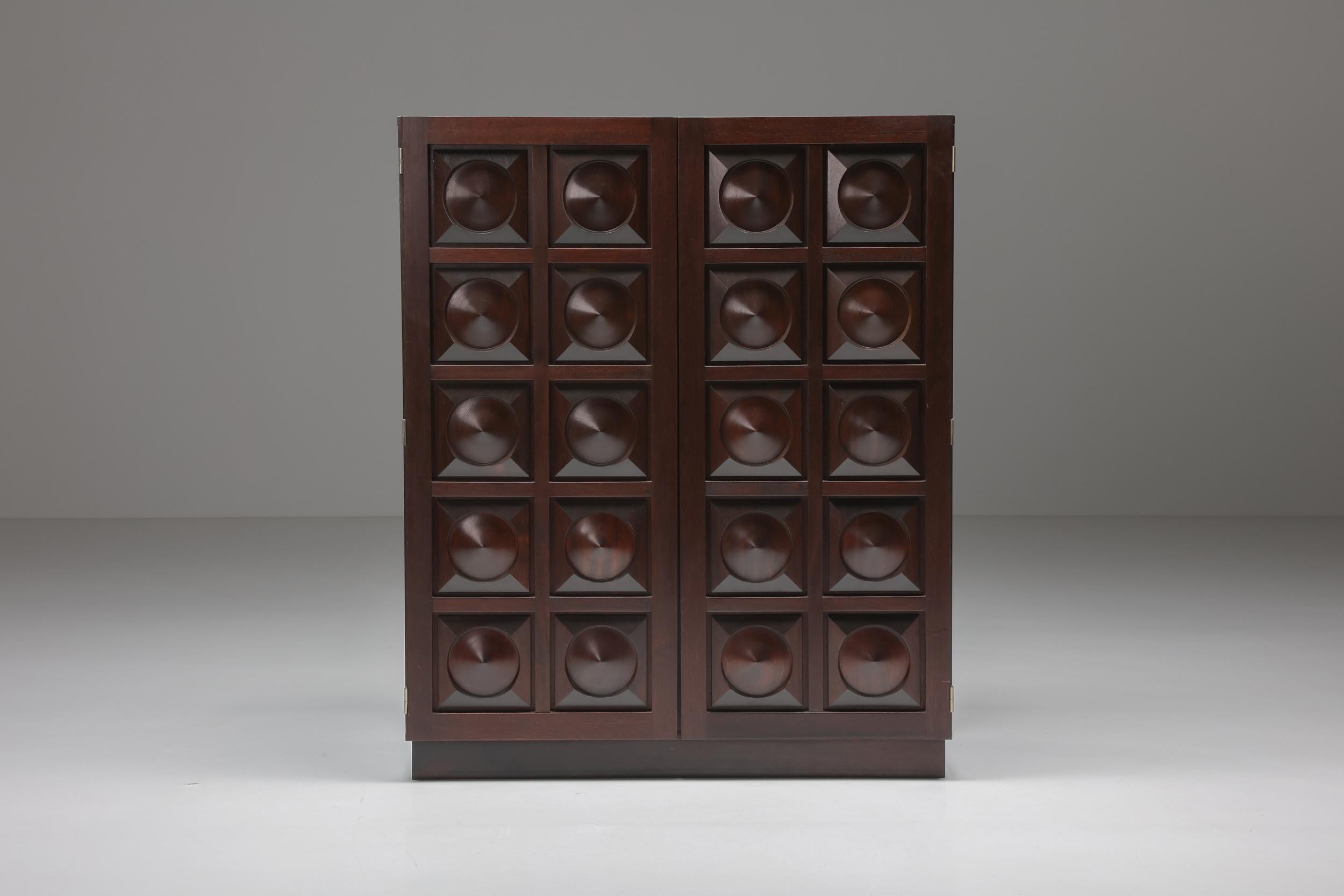 Brutalism; Belgian design; Cabinet; Dry bar; Mahogany; Woodworking; Mid-century modern; Graphical shapes; 

Belgian brutalist high board in dark brown stained mahogany. Showing amazing woodwork on the two-door panels. A combination of geometrical