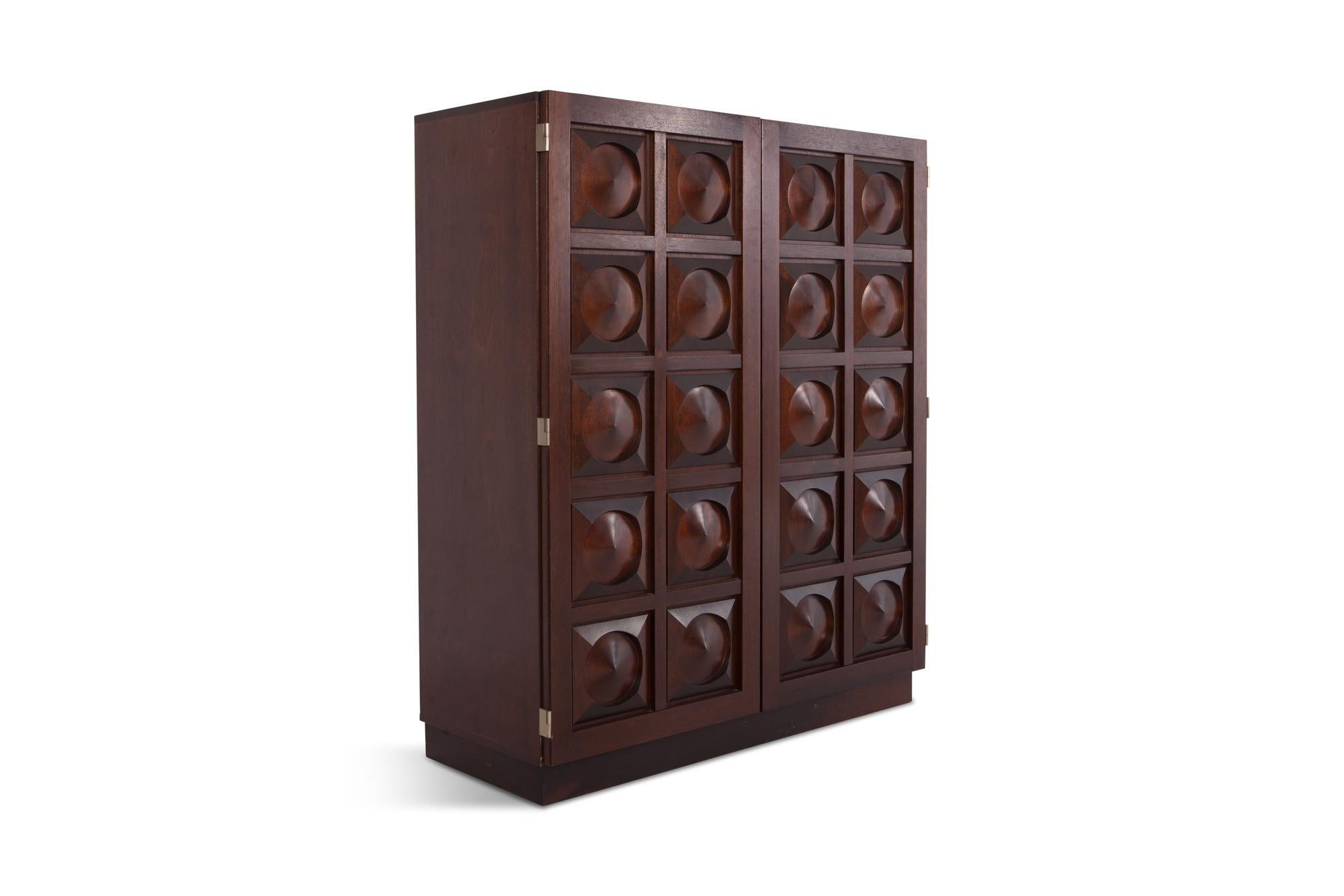 Brutalist high board in dark brown stained mahogany. 

A true Belgian brutalist, showing amazing woodwork on the two-door panels. A combination of geometrical shapes is combined into a graphical panel. 

The mahogany is stained into a ruby-red
