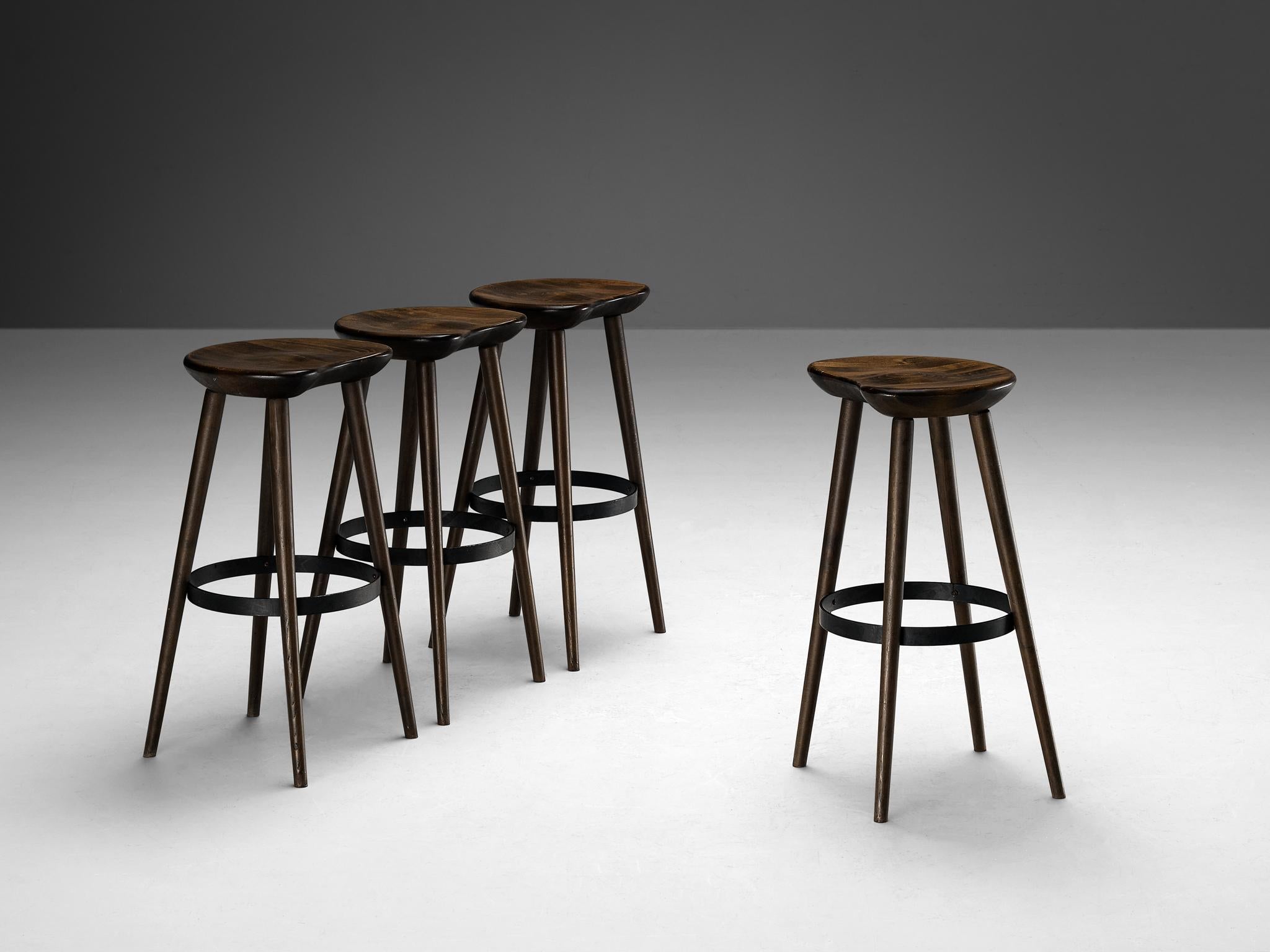 Brutalist bar stools, stained beech, Europe, 1970s

Exquisite and robust, these bar stools showcases a striking patina that is characteristic of the brutalist design prevalent in the 1970s. Crafted during this iconic era, these chairs feature seats