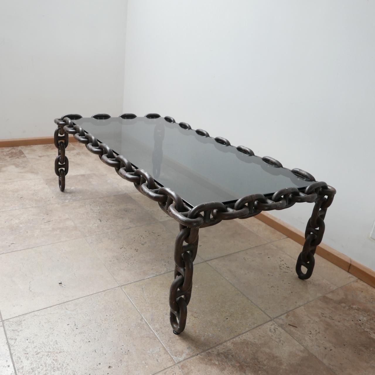 A large wide coffee table. 

Belgium, c1970s. 

Metal, iron chains with a fresh smoked glass top. 

Heavy, good quality and wildly stylish. 

Dimensions: 46 H x 136 W x 72 D in cm. 

Delivery: POA

  