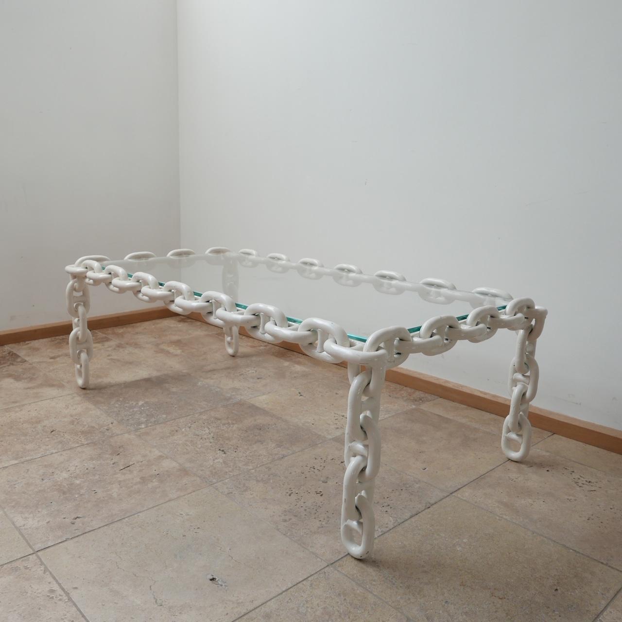 A large wide coffee table. 

Belgium, c1970s. 

Metal, painted white iron chains with a fresh clear glass top. 

Heavy, good quality and wildly stylish. 

Dimensions: 46 H x 136 W x 72 D in cm. 

Delivery: POA.
 
 