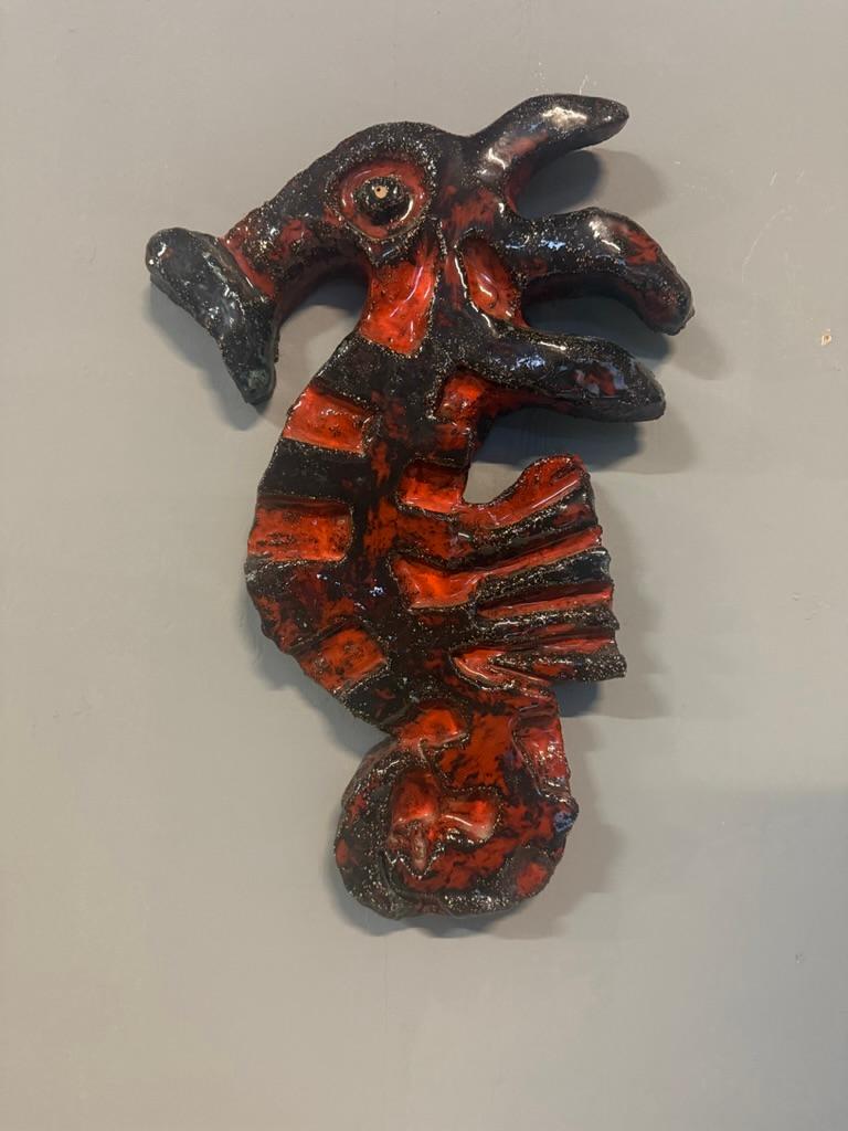 Stunning, large and heavy weighted ceramic seahorse designed by Belgian ceramist Lemahieu. The ceramic features a layer of brown/black and warm orange glaze with slight blue speckles. 

This piece is a beautiful decorative accessory, ideal for