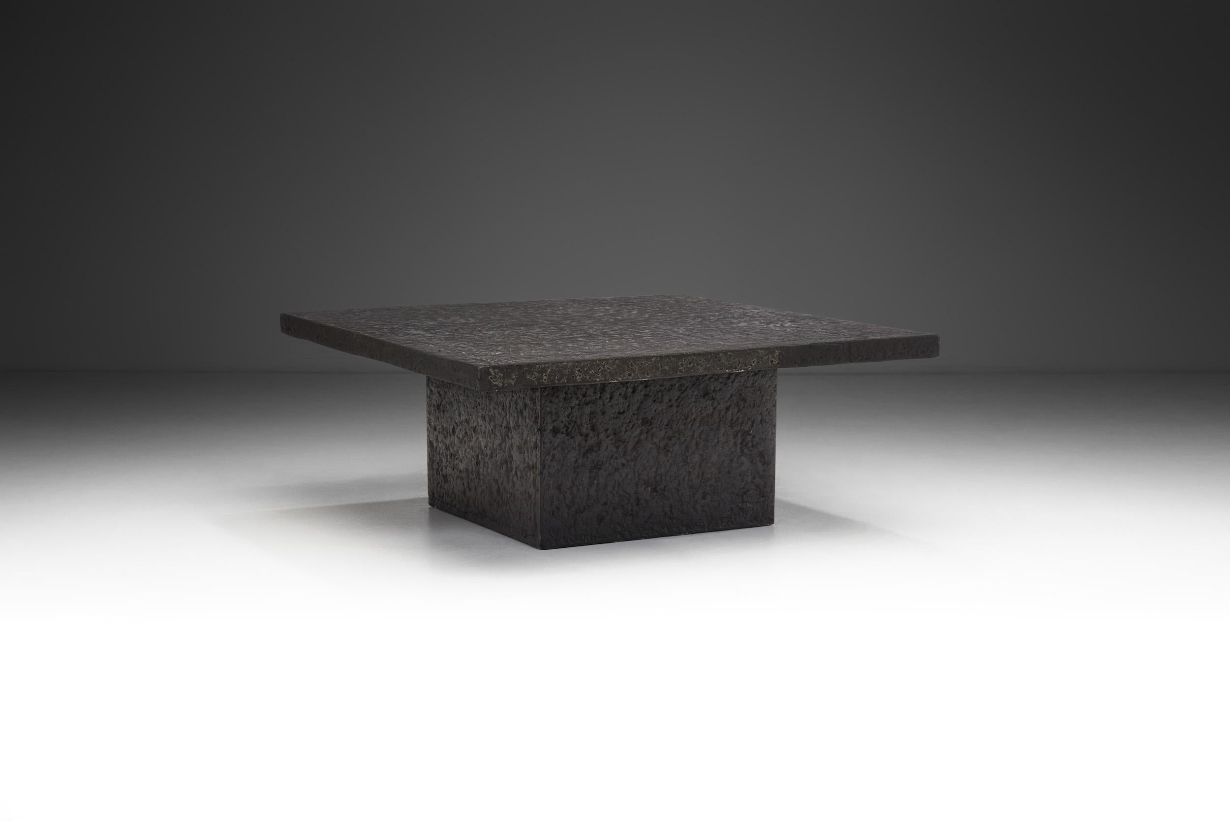 The essence of Brutalism, an architectural movement originating in the mid-20th century, is captured in the un-embellished design of this coffee table. It proudly showcases raw, bold geometric forms, and a prioritization of function over adornment.