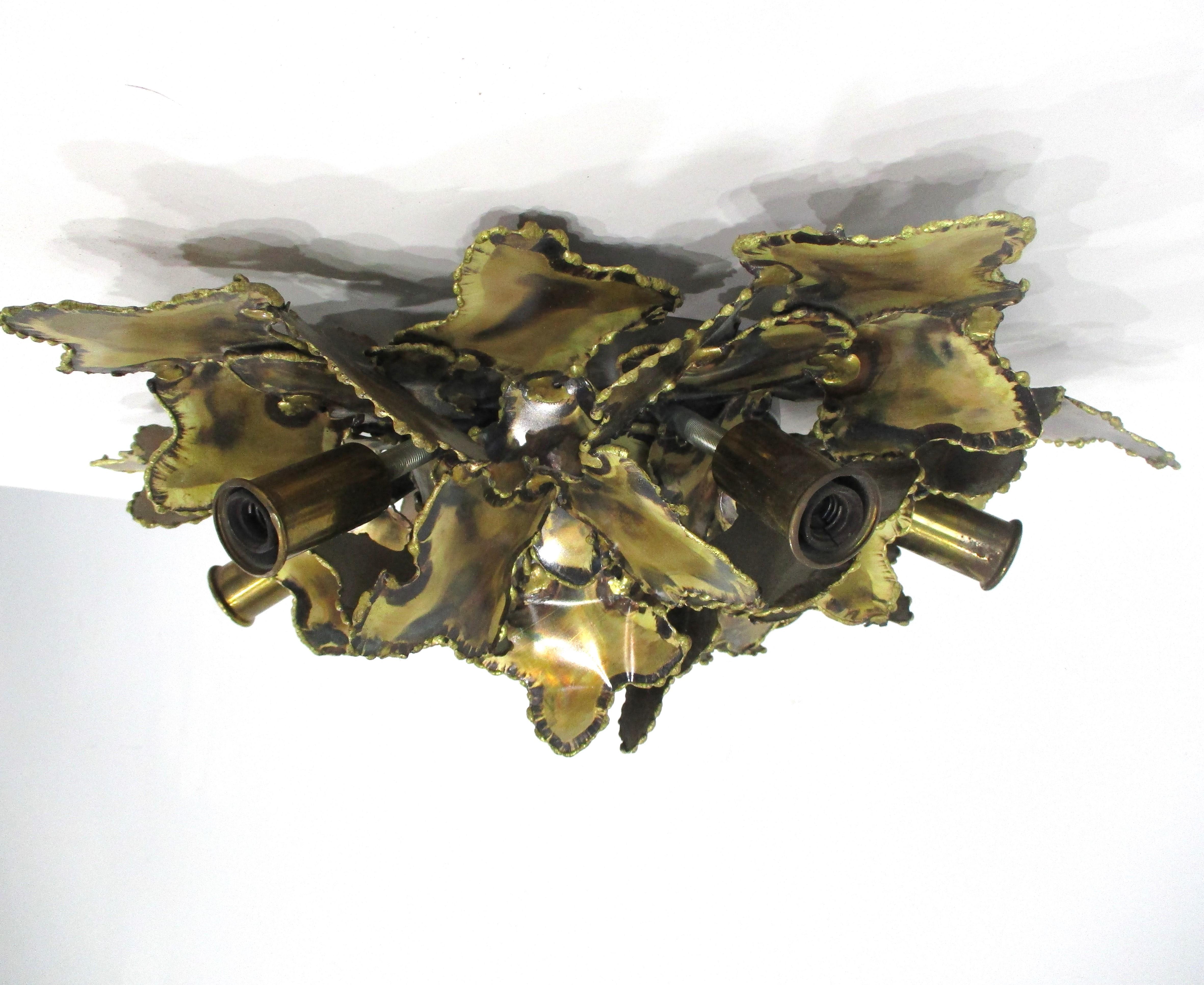 A brass sculptural Brutalist torch cut and welded flush mount ceiling light or could be used as a sconce  . Designed by Tom Greene known for his creative lighting work in metal during the 60's and 70's , this one is hard wired for installation and