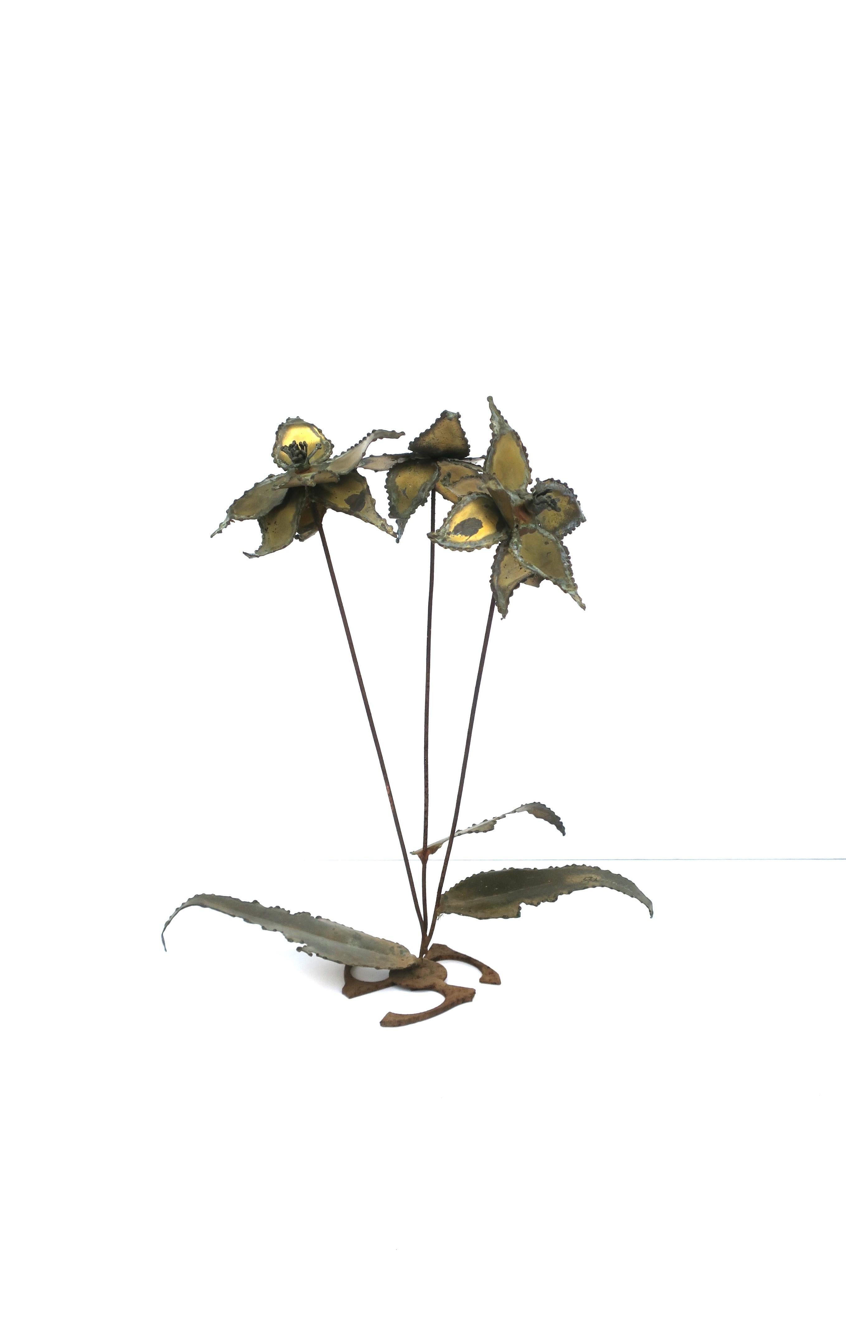 A signed brass and metal sculpture of flowers and leaves, Brutalist period, in the style of designers Silas Seandel or C. Jere, circa mid-20th century. A Brutalist sculpture of flowers and leaves in a distressed patinated brass and metal. Piece is