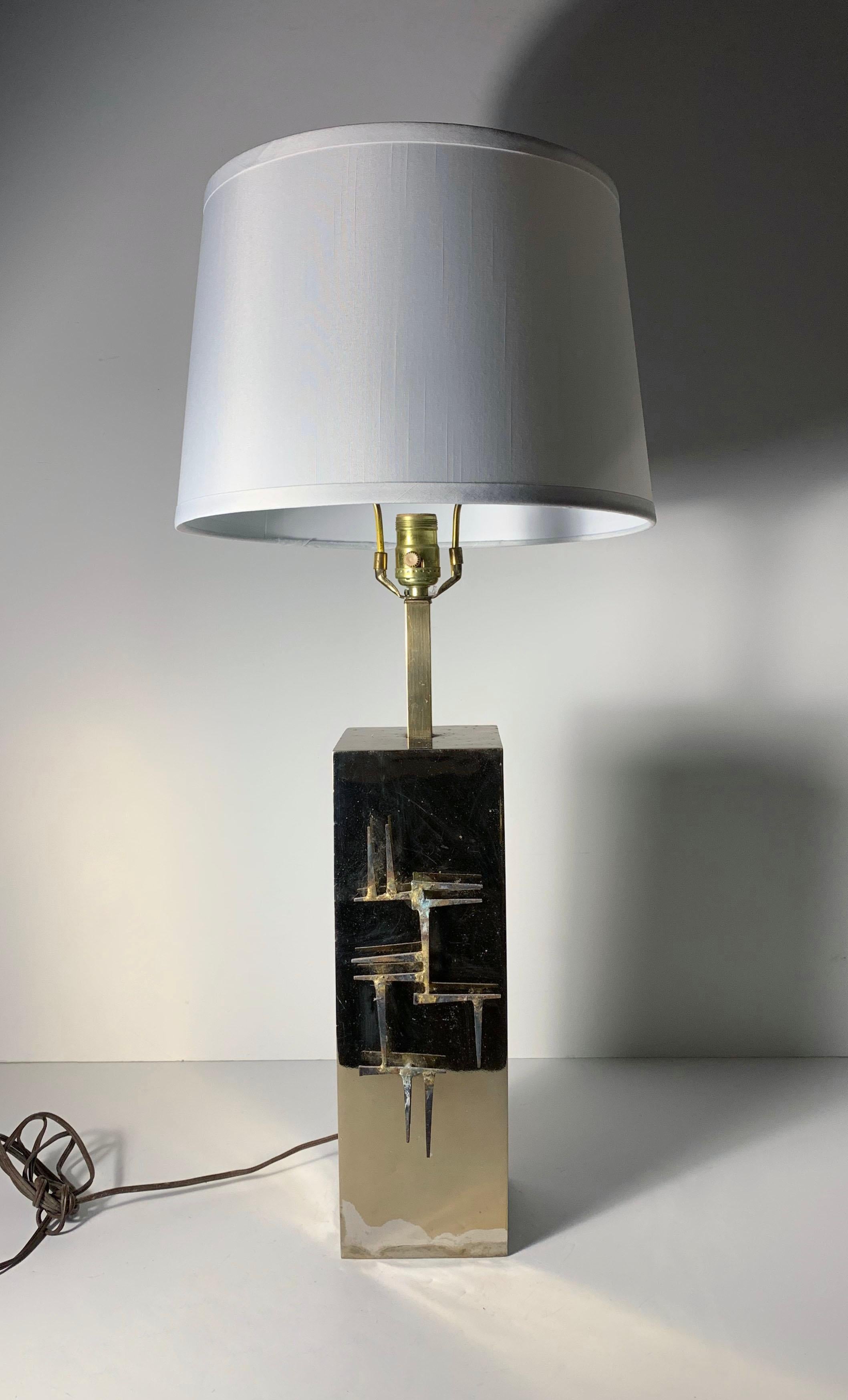 Brutalist brass table lamp with abstract nail applique relief by Laurel
Some loss to brass finish towards bottom as shown. some minor pitting and patina aging.
Sold sans shade.

Style of Paul Evans, Silas Seandel
      