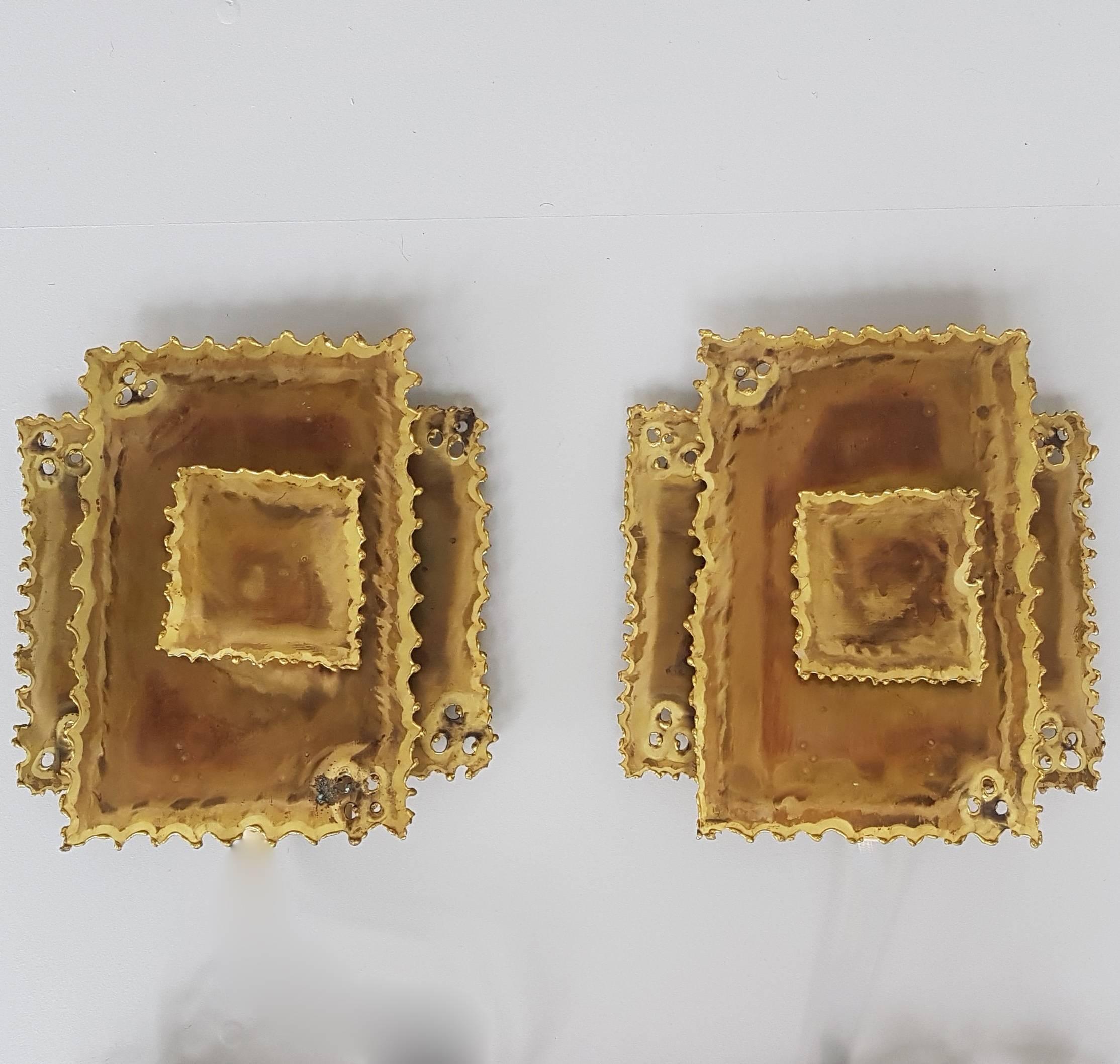 Two vintage Danish brass wall sconces made by Holm Sørensen & Co and designed by Svend Aage Holm Sørensen. The squares are made of acid treated brass. 

They are in very good condition and fully functional and ready to use.