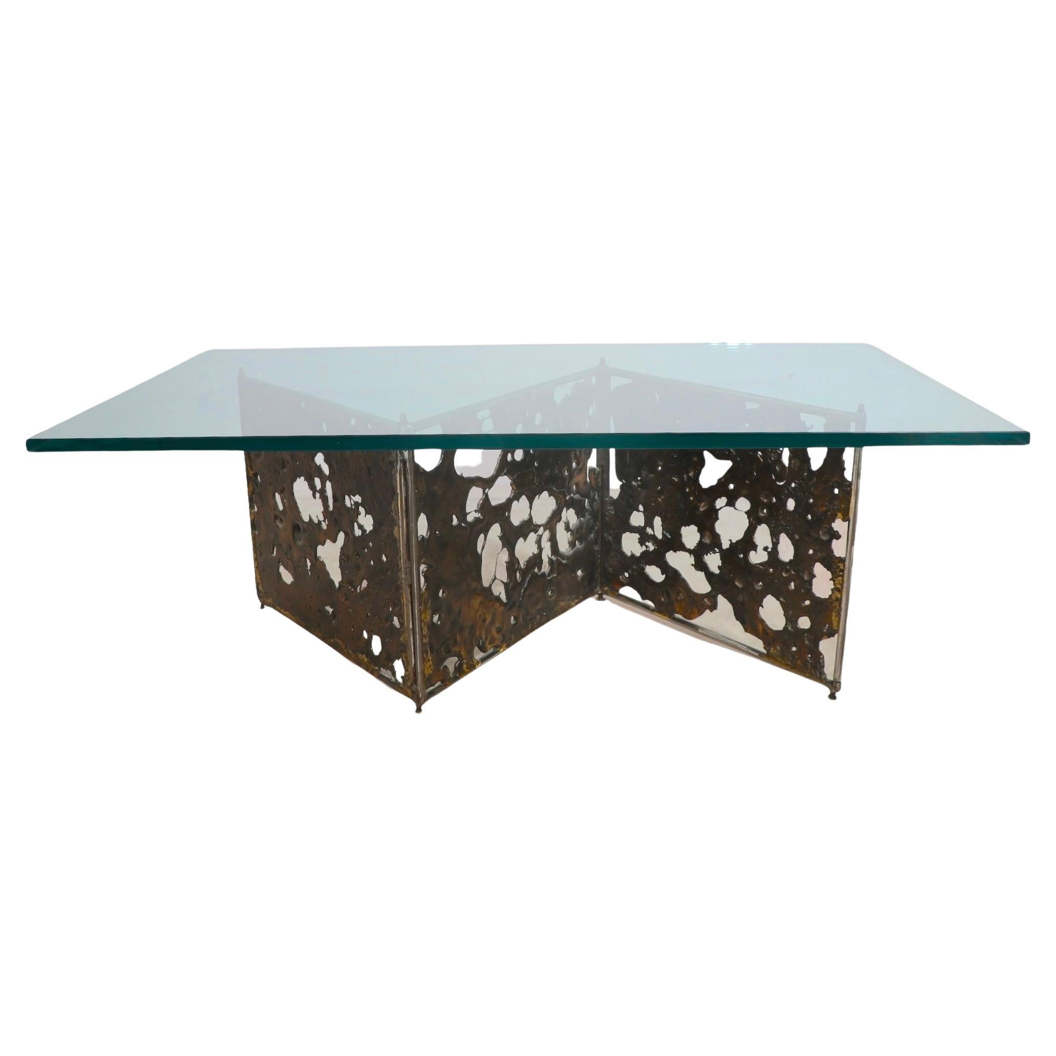 Incredible Brutalist coffee table by recognized master of the style Silias Seandel, signed and dated ( 1988 ). The table features a zig zag form base having three bronze insert panels, each 19.5 W x 16 H and its original thick ( .75 in. ) plate