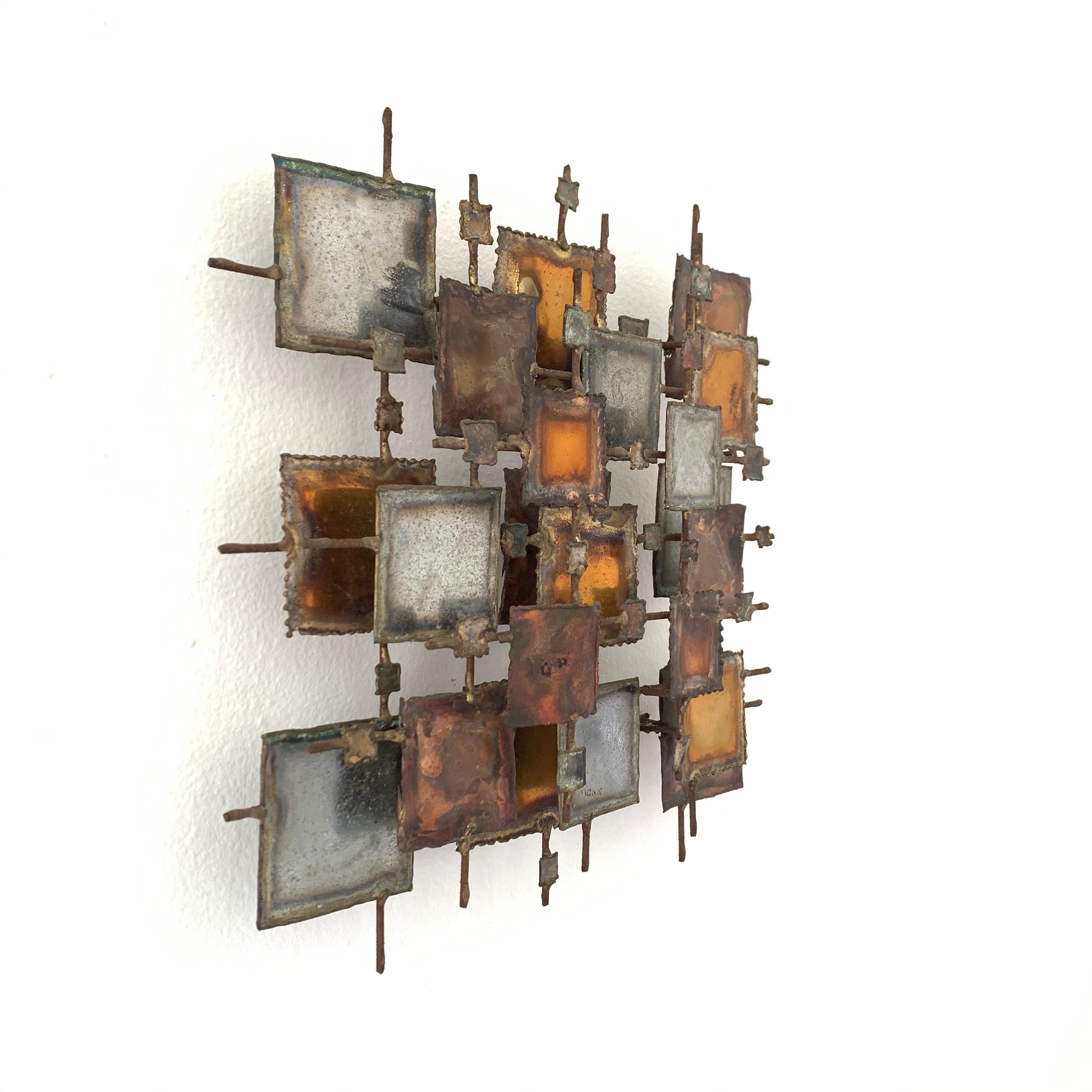 Brutalist stacked squares wall sculpture rendered in welded and forged bronze, copper, brass, and steel. Designed and made by MONK, 1970s.