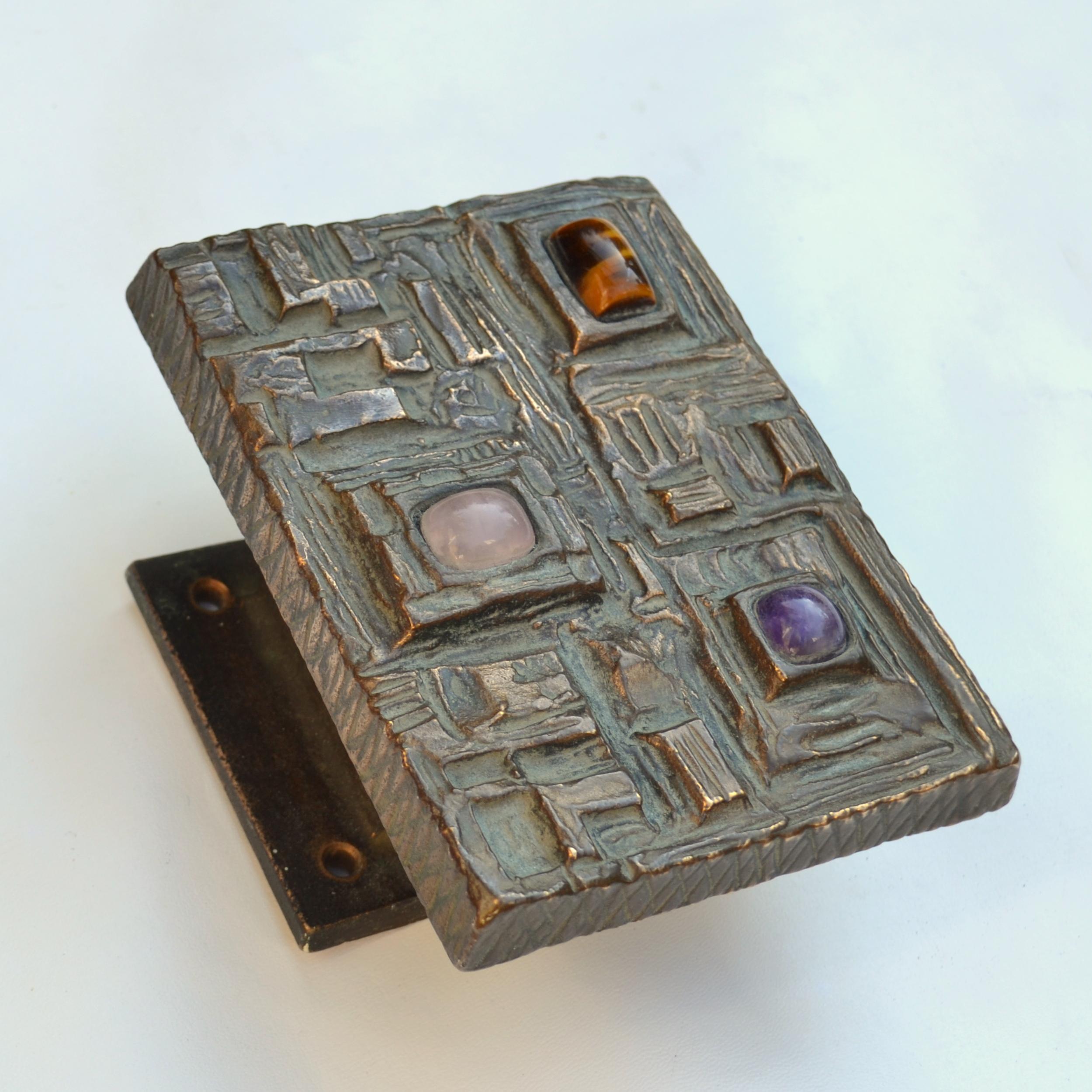 Abstract bronze door handle with three semi-precious stones (tigers eye, amethyst, rose quartz) that stand out against Brutalist relief with original patina. This 1970s rich in detail door handle for a push and pull door gives real personality to a