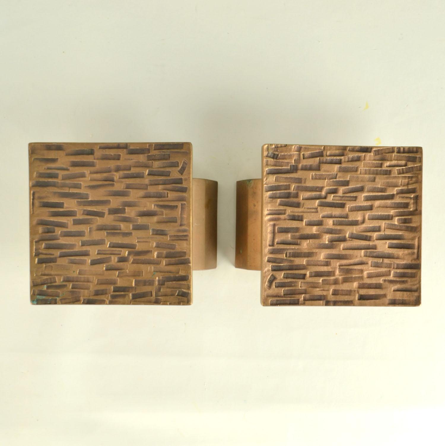 Brutalist pair of bronze relief with subtile geometric pattern with repetition of embossed rectangles is made in the 1960-70's. They are a work of art, made for doors of cast bronze are in perfect condition. The bronze is lightly oyidized, creating