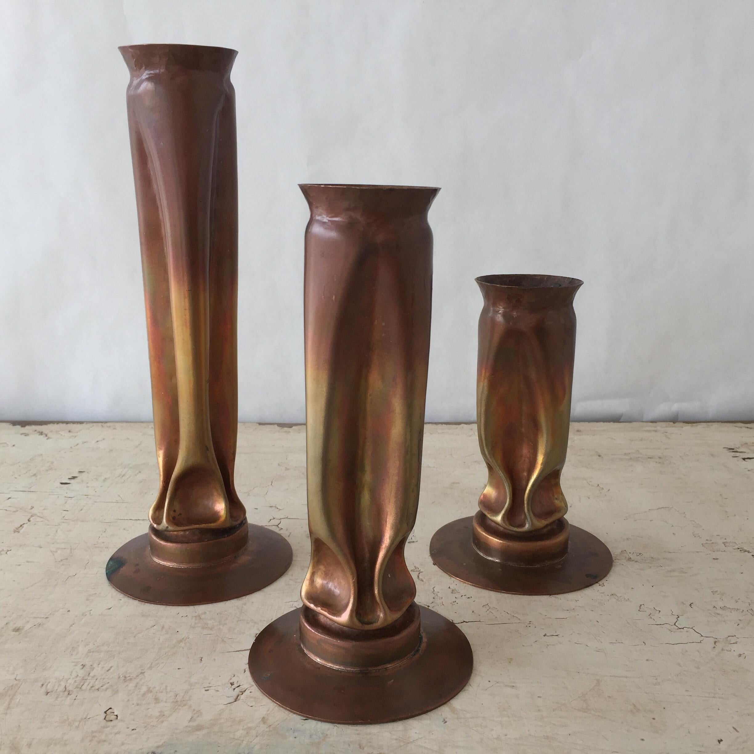 Pair of large 1970s Brutalist copper candleholders by master sculptor Thomas Roy Markusen. Tall, tortured form of hammered and shaped copper has an organic aesthetic. Pinched and indented elements provide internal support for a pillar candle, while