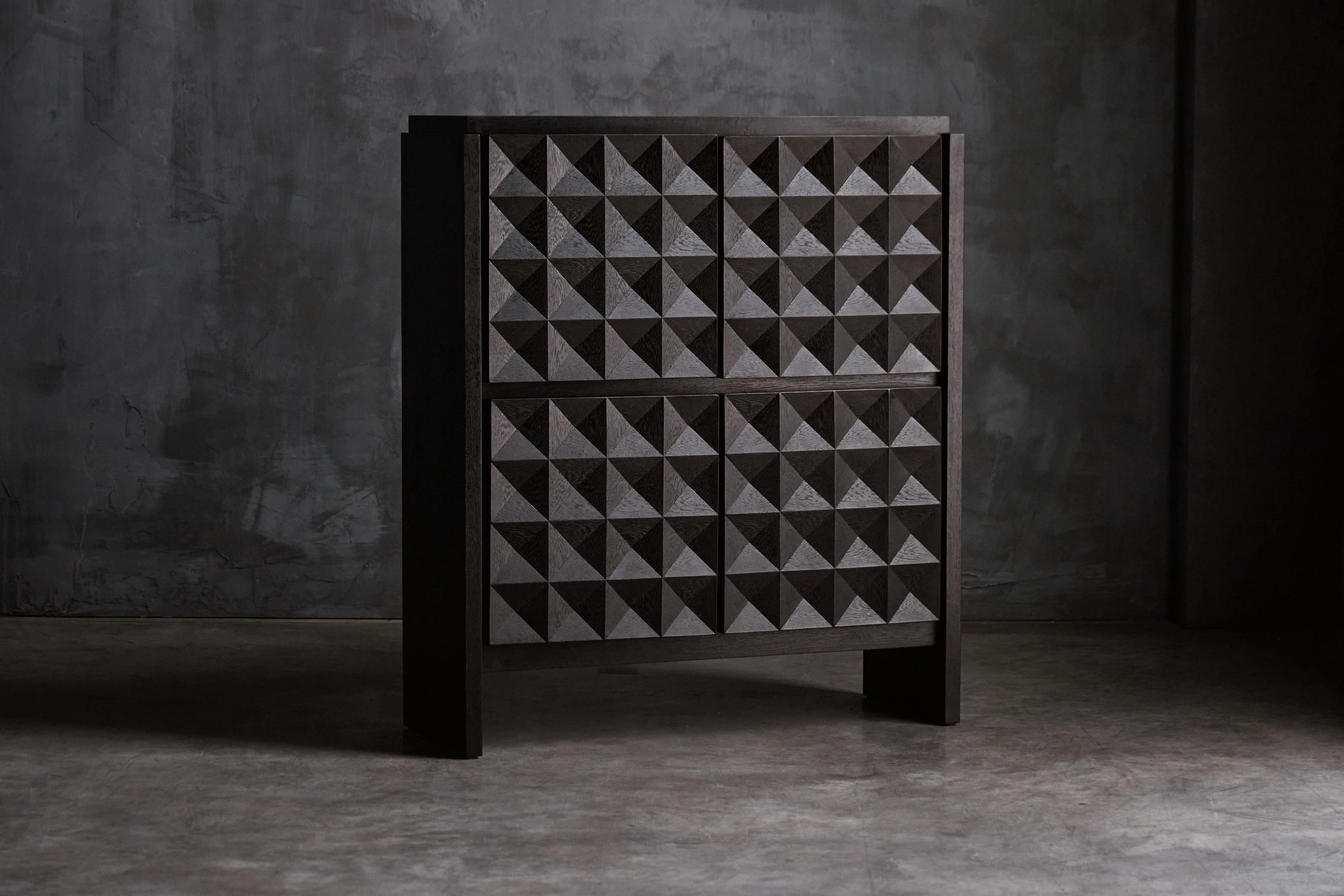 De Coene sideboard, crafted in Belgium during the 1970s, made from high-quality stained oak. The sideboard features a minimalist geometric pattern on the cabinet doors, which adds a striking visual element to its clean, modern lines. The warm, deep