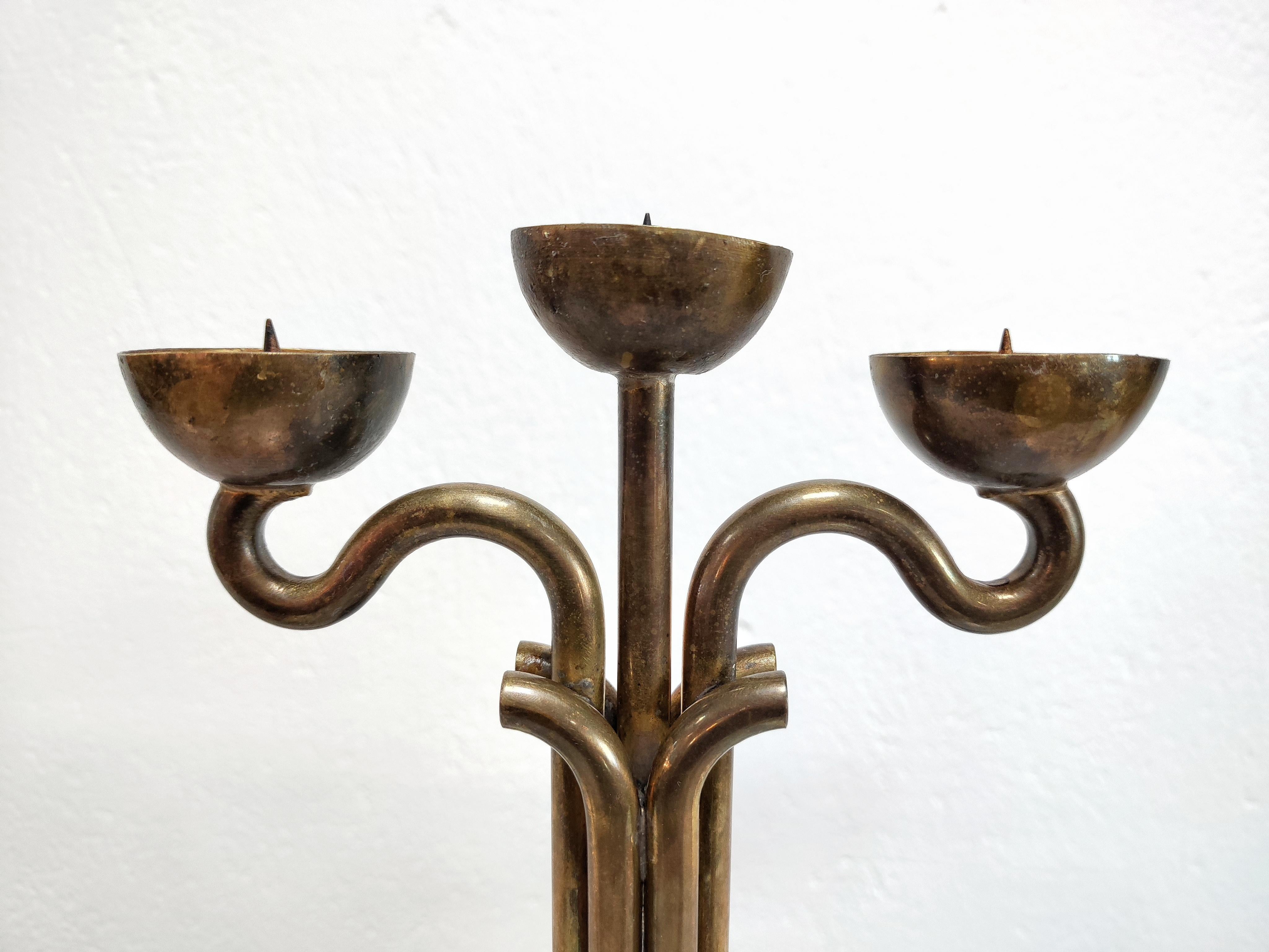 In this listing you will find a rare Brutalist three-arm candlestick holder done in bronze and chrome. It features sculptural form, with thick bronze sticks curved in symmetrical direction. The bronze sticks are attached to the chrome base. Very