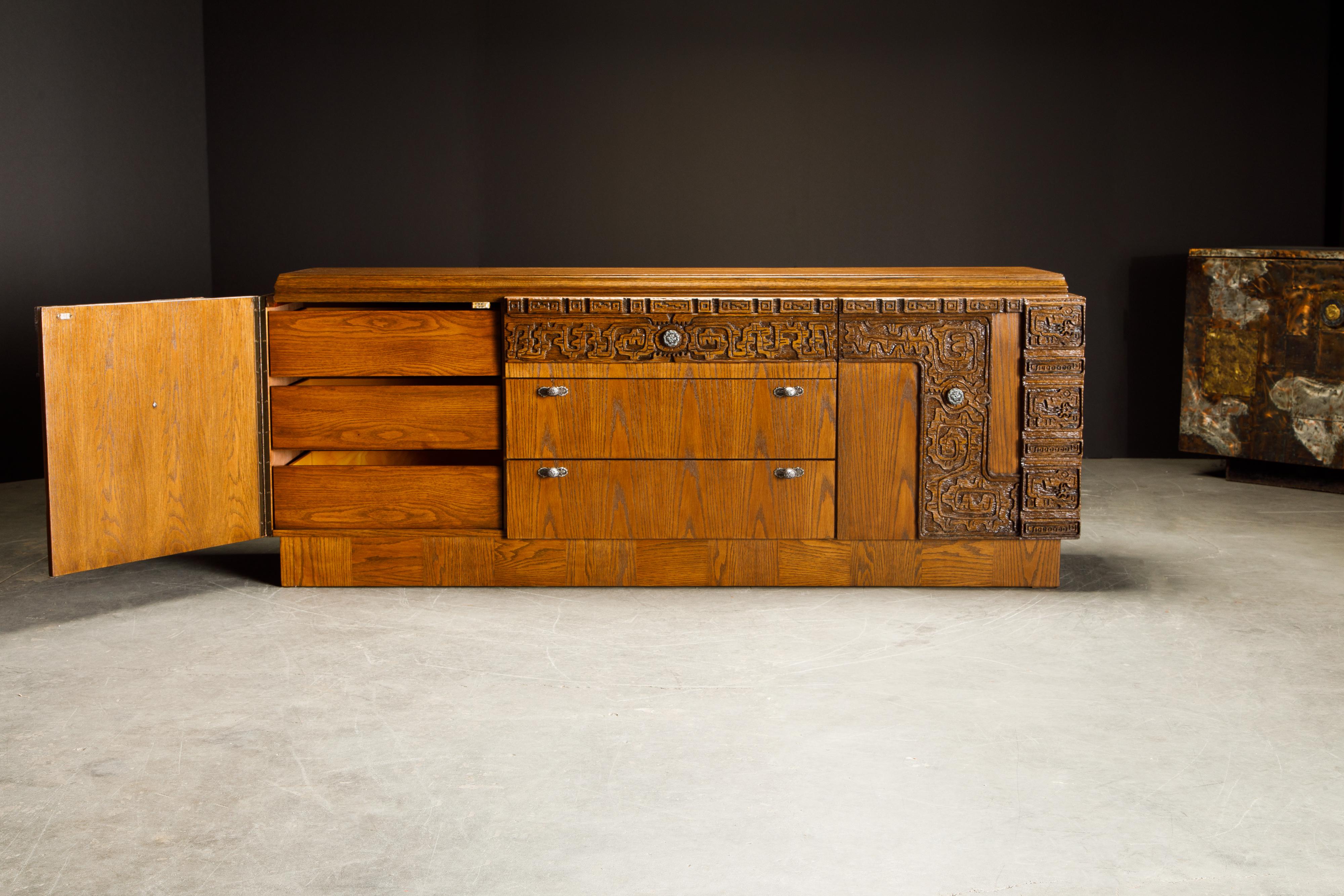 We beautifully restored this incredibly unique brutalist Mid-Century Modern dresser / credenza which features heavy pewter handles and door pulls, carved cerused oak in a Mayan / Aztec style, beautiful oak wood grain throughout, and plenty of