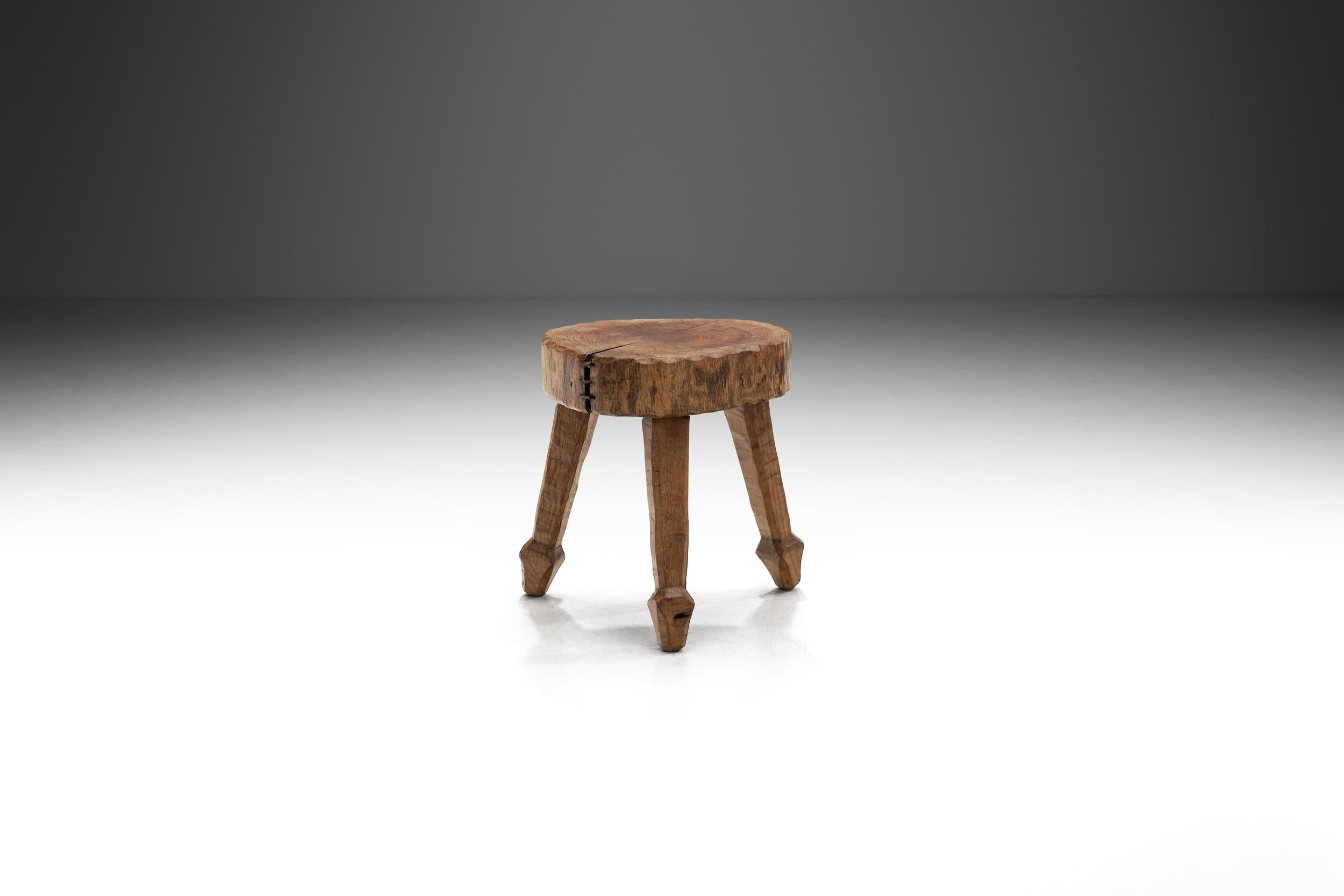 In the dimly lit corners of mid 20th century, Belgian craftsmanship emerged the brutalist movement. This solid oak wood stool, crafted during the 1950s, stands as a tangible embodiment of the brutalist architectural tenets that swept through the