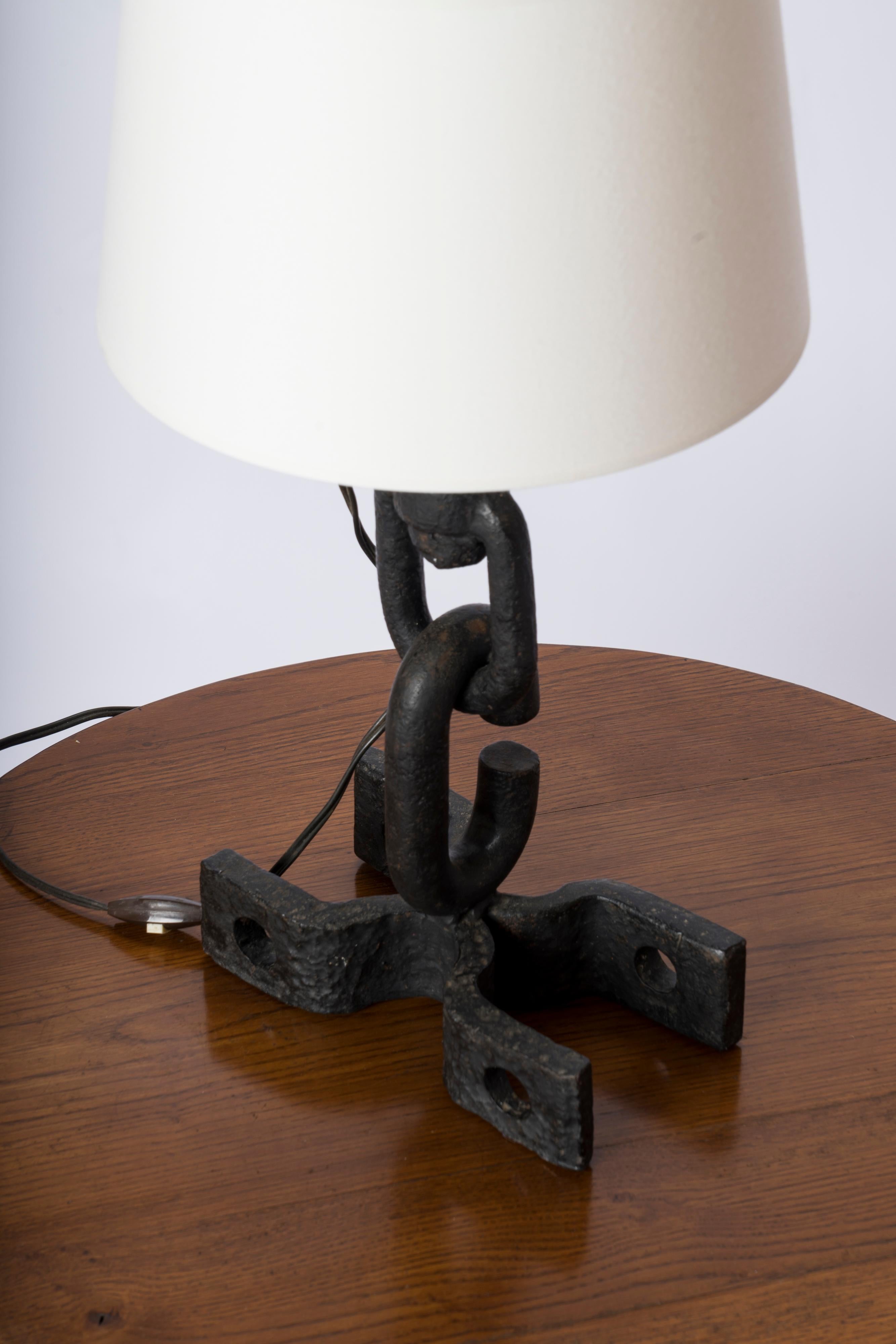 Brutalist cast and wrought iron table lamp in the style of Franz West. Made of welded and assembled solid iron pieces. 
European socket and wiring.
This lamp will ship from France and can be returned to either France or to a NY USA location.
Price