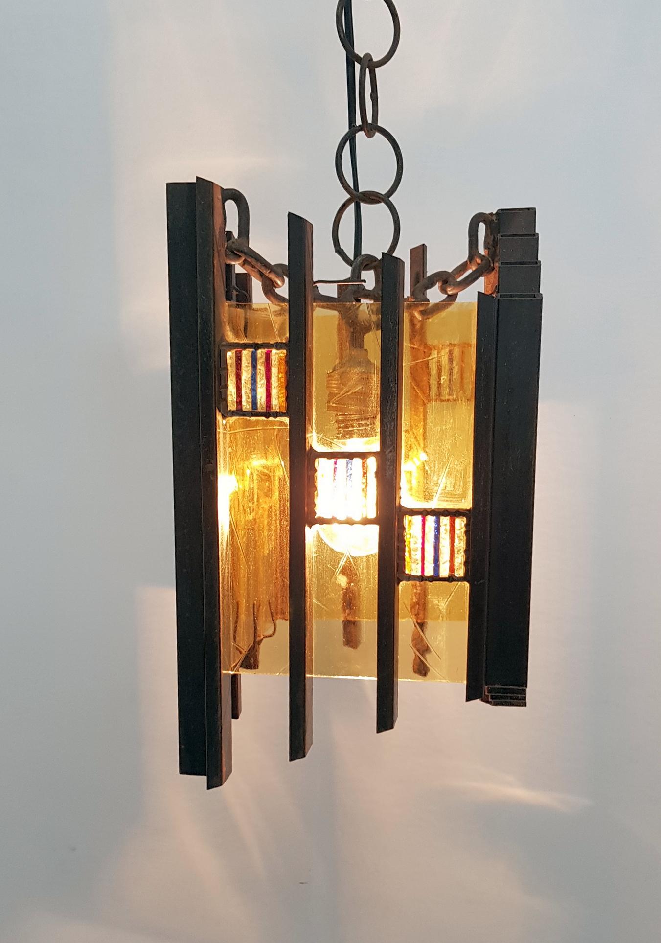 Rare Brutalist style ceiling lamp handmade by Italian manufacturer Longobard in iron and colored glass. In good working condition. The height of the lamp is 35cm without chain which measures 12cm. The original chain can be exchanged for a longer one