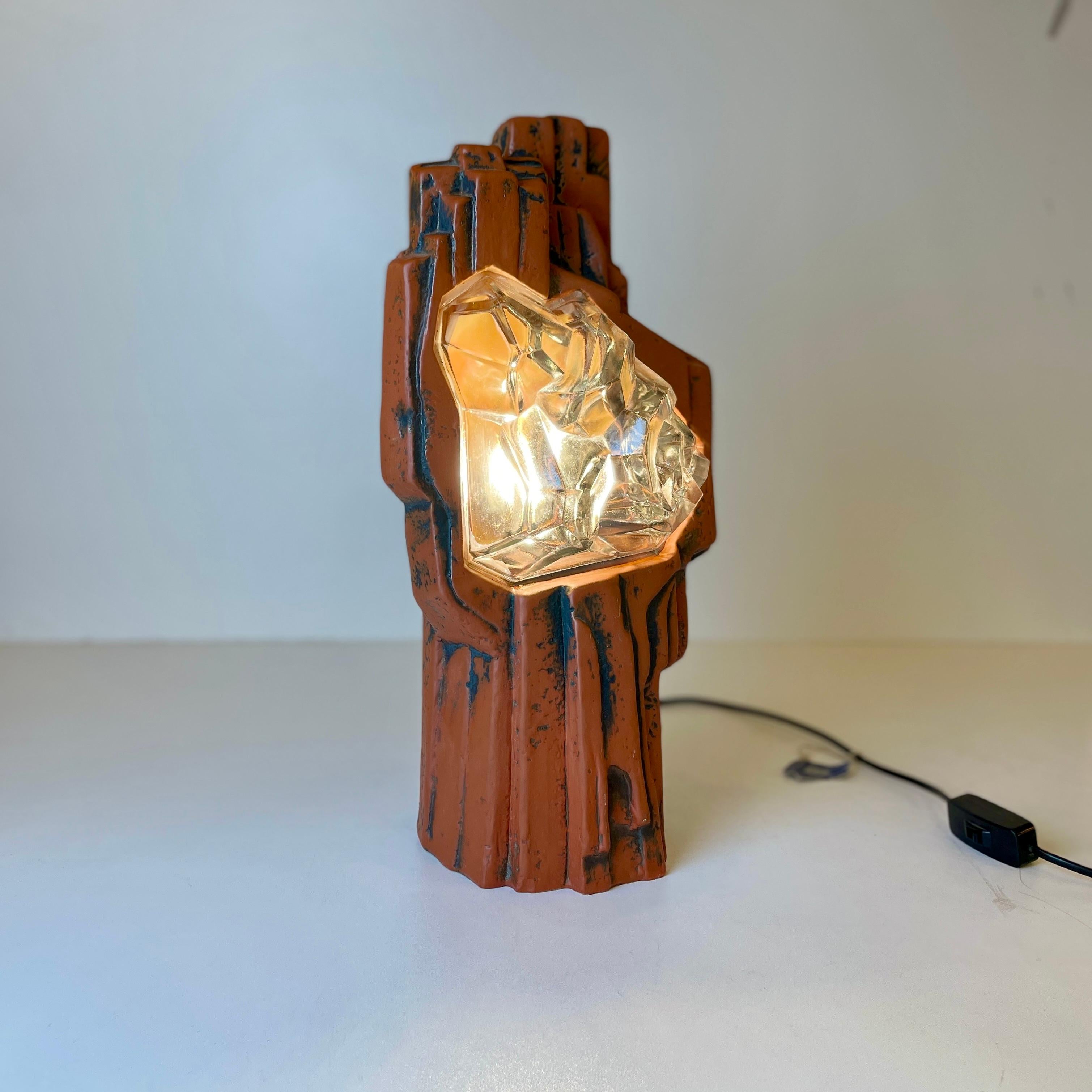 Incredible and rare German table lamp made of ceramic and glass.
Designed to look like a rock with a glowing crystal inside.
It has a triangular VDE label, the VDE mark is a test mark issued by the testing and certification institute of the VDE -