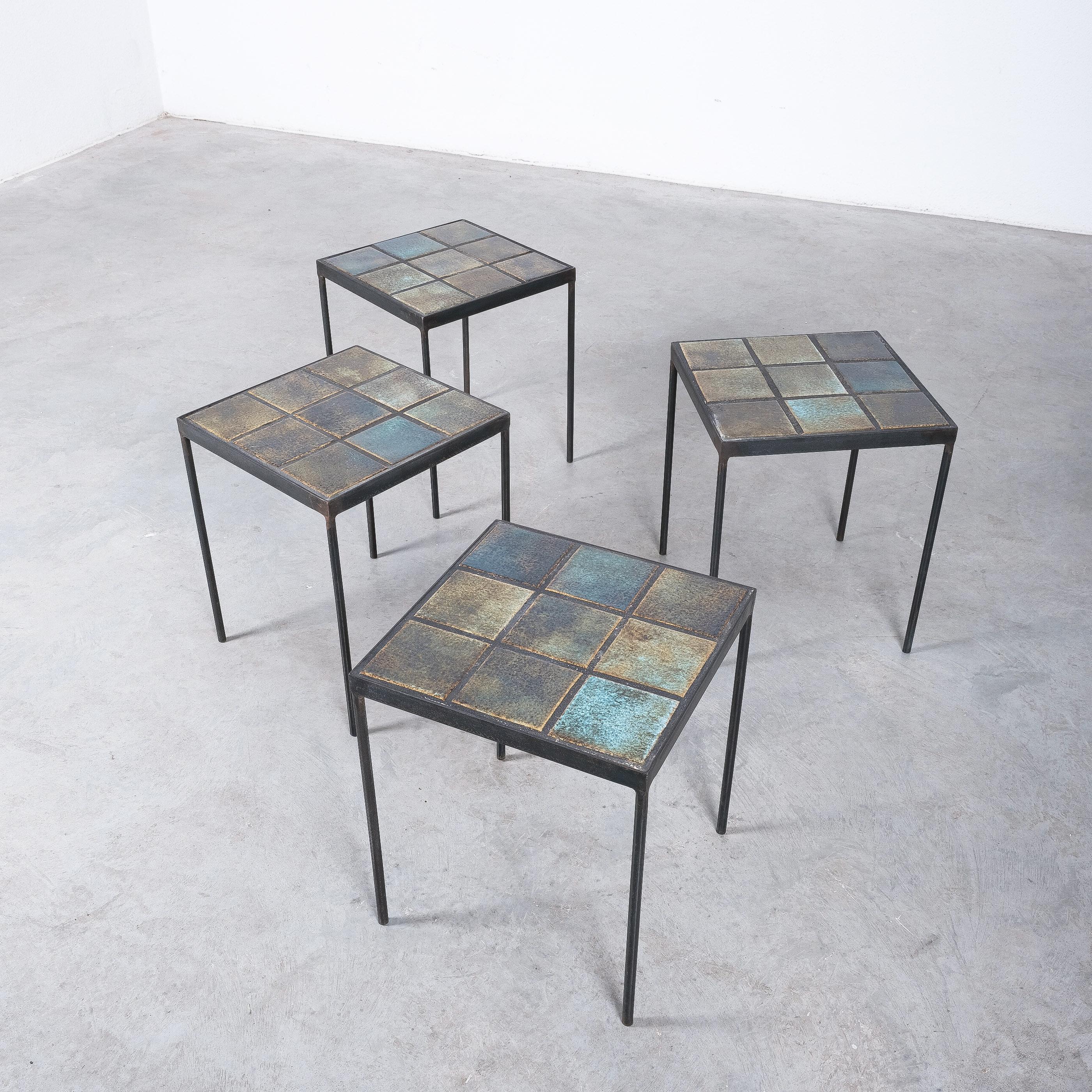 Ceramic tables on blackened iron base, France circa 1970

We have priced them per pair, 2 pairs available.

A very well balanced set of gradient ceramic tiles tables in green, blue yellow tones. Unique set of tables with individual tones of