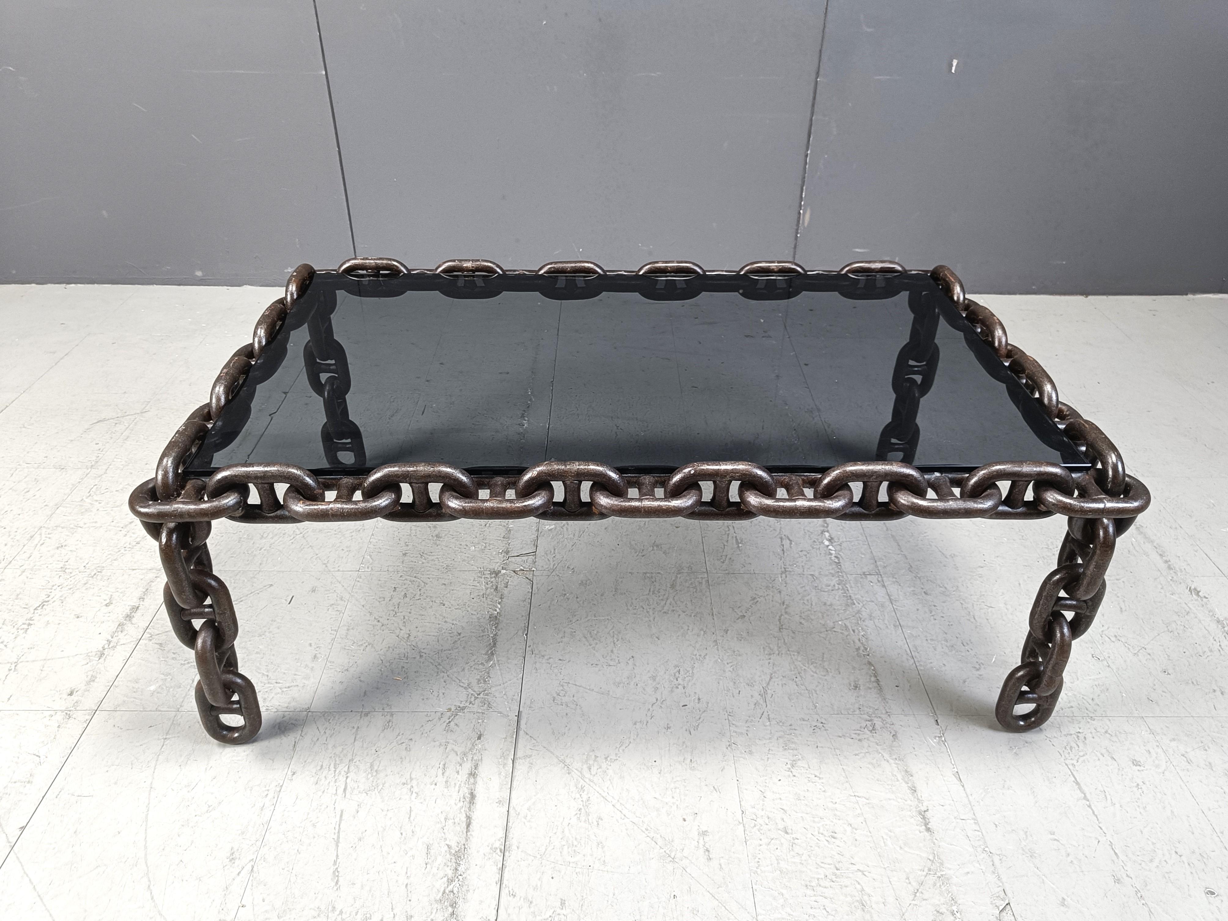 Steel chain link coffee table with a smoked glass top.

Very cool coffee table to create a nice contrast.

Industrial, brutalist style.

1970s - Belgium

Dimensions:
Height:  47cm
Width: 120cm
Depth: 72cm

Ref.: 25012001

*Images are always part of