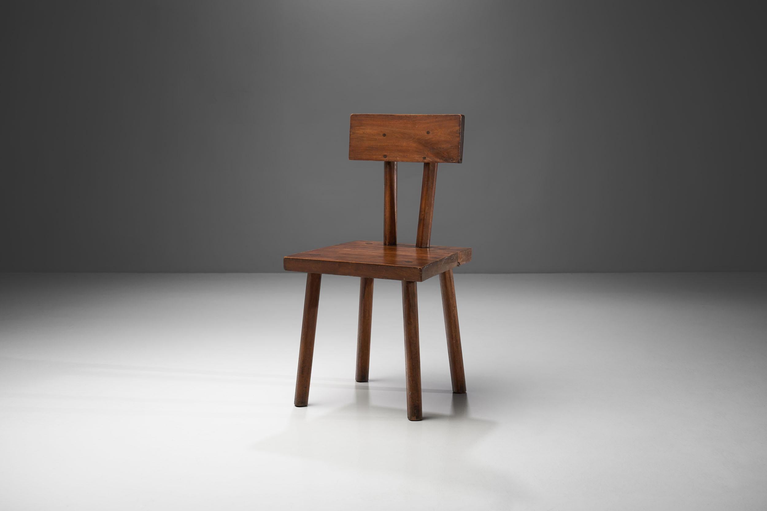 Brutalist handmade chair made of solid wood from circa 1950s. With a robust organic form and an earth-toned palette, this chair is the embodiment of Brutalism. The chair has a startling rawness, but with its warm-toned and slightly asymmetrical body