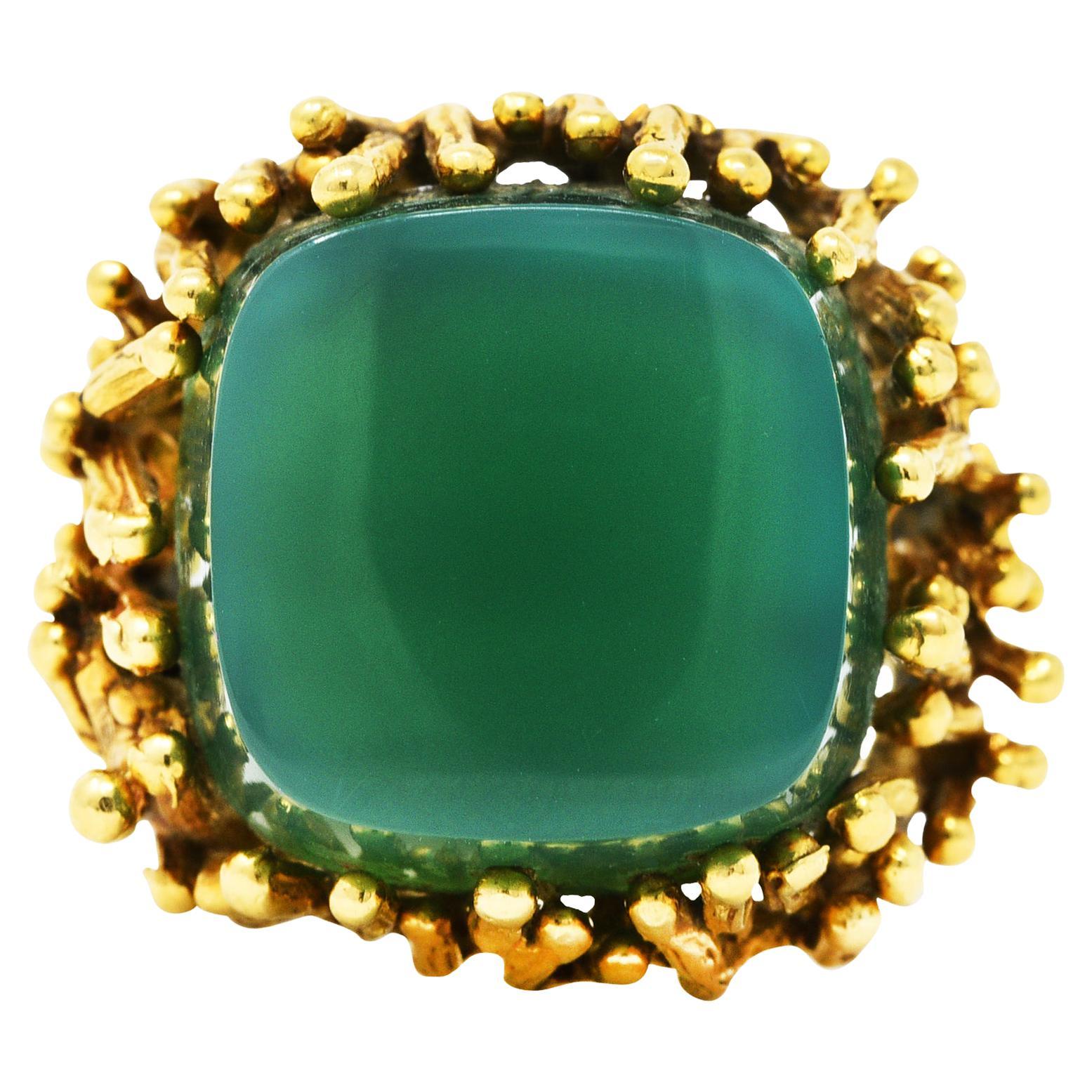 Ring is comprised of branching organic tendril forms centering a prong set chrysoprase

Tablet is cushion shaped and deeply cut - translucent and strongly blueish green in color

With grooved texture throughout

Stamped 750 for 18 karat