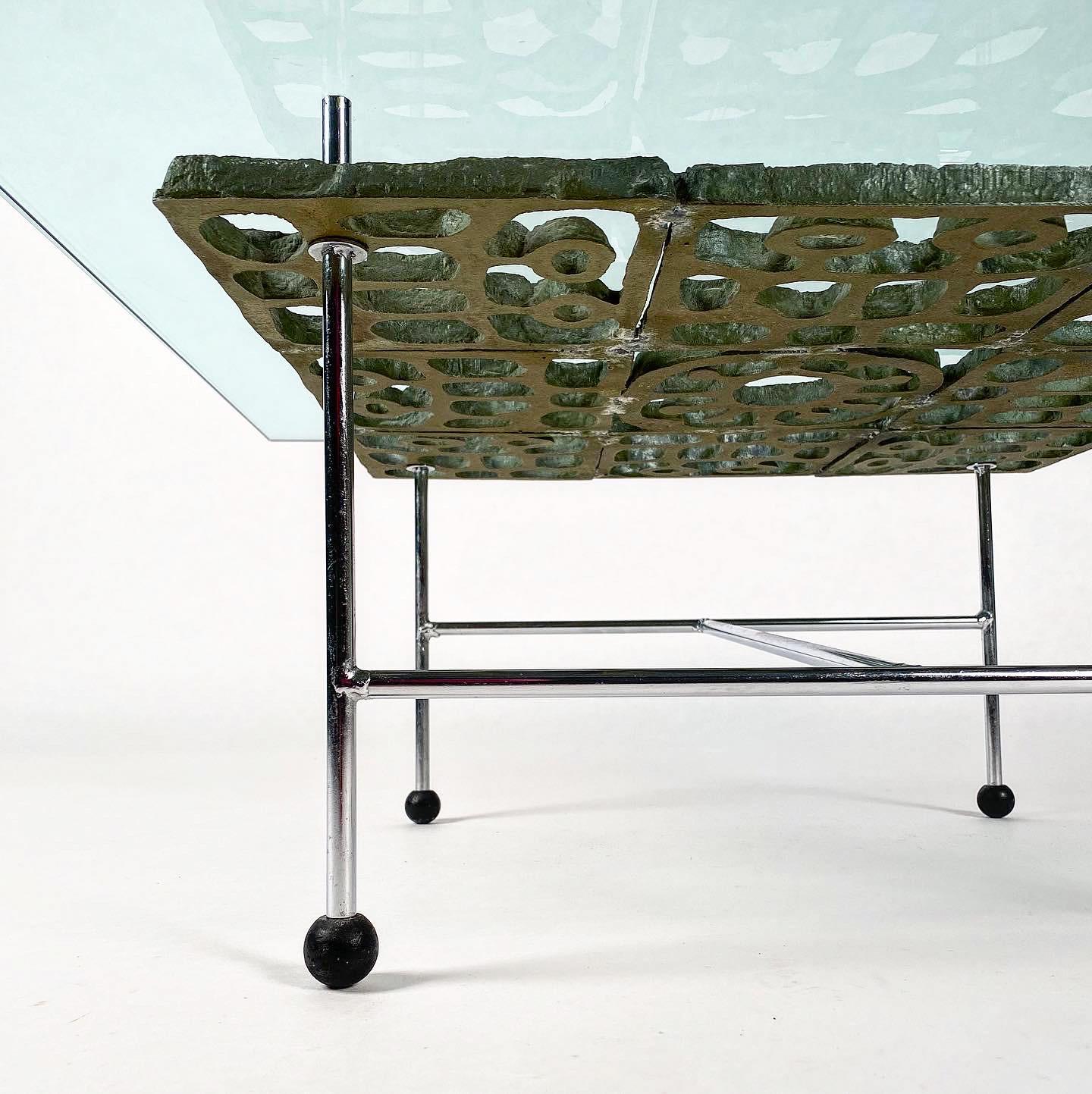 Fabulous one of a kind cocktail table by Don Drumm. The sculptural element is cast aluminum in a brutalist-style sun motif. Square glass top, (3/4” thickness) floats above the sculpture on a streamlined but sturdy steel frame. Black plastic ball